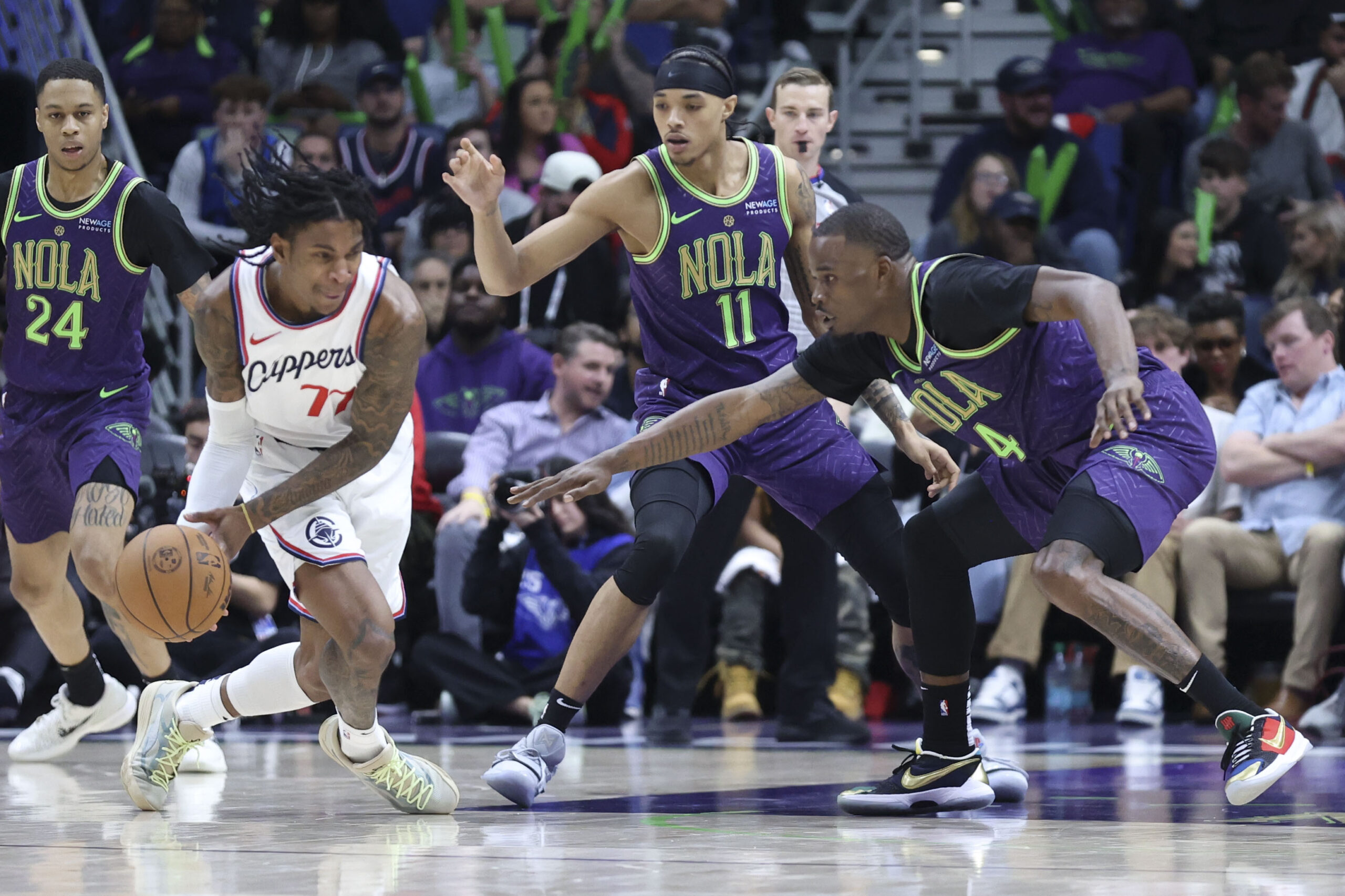 Clippers guard Kevin Porter Jr. tries to gain control of...