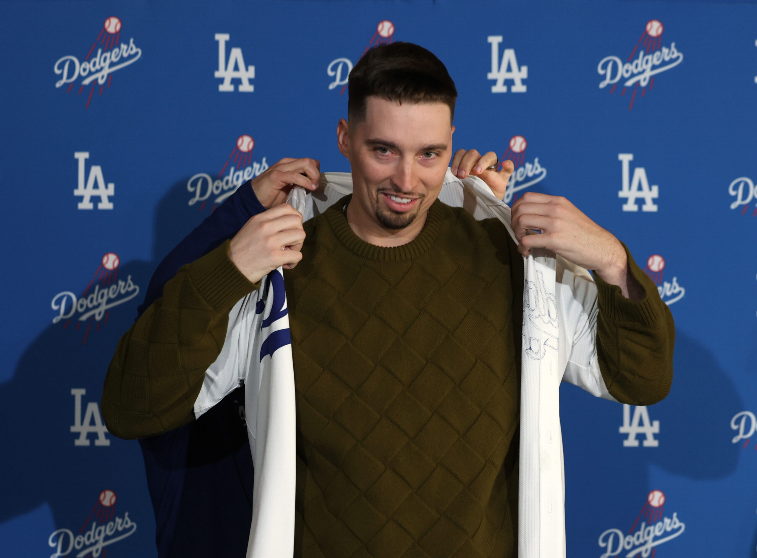 New Dodgers pitcher Blake Snell reacts as he puts on...