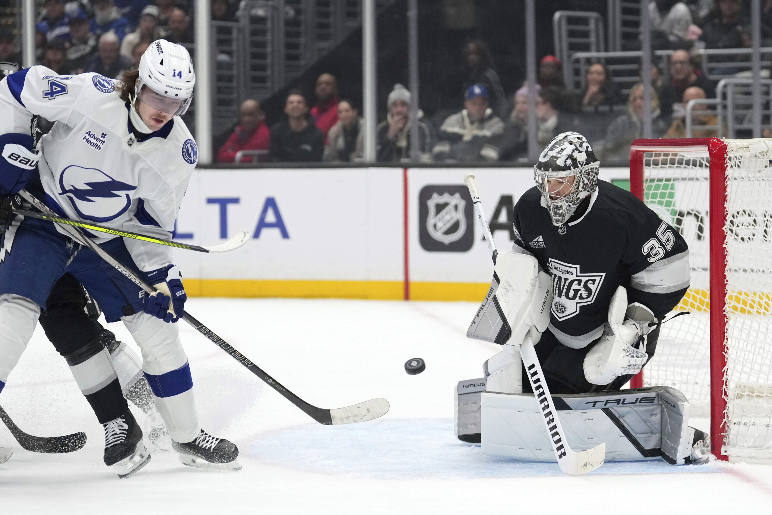 Tampa Bay Lightning center Conor Geekie, left, tries to top...