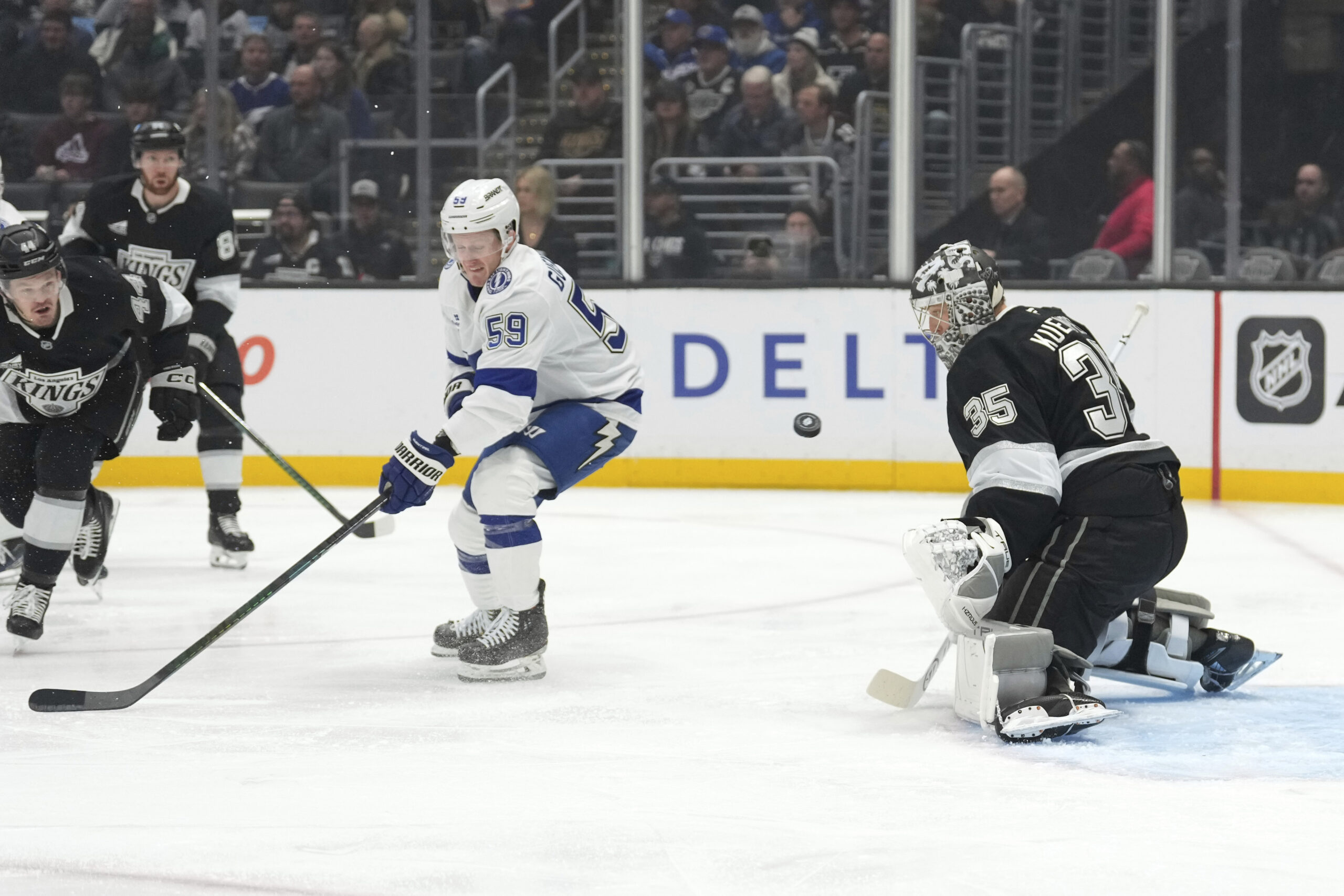 Kings goaltender Darcy Kuemper, right, stops a shot as Tampa...