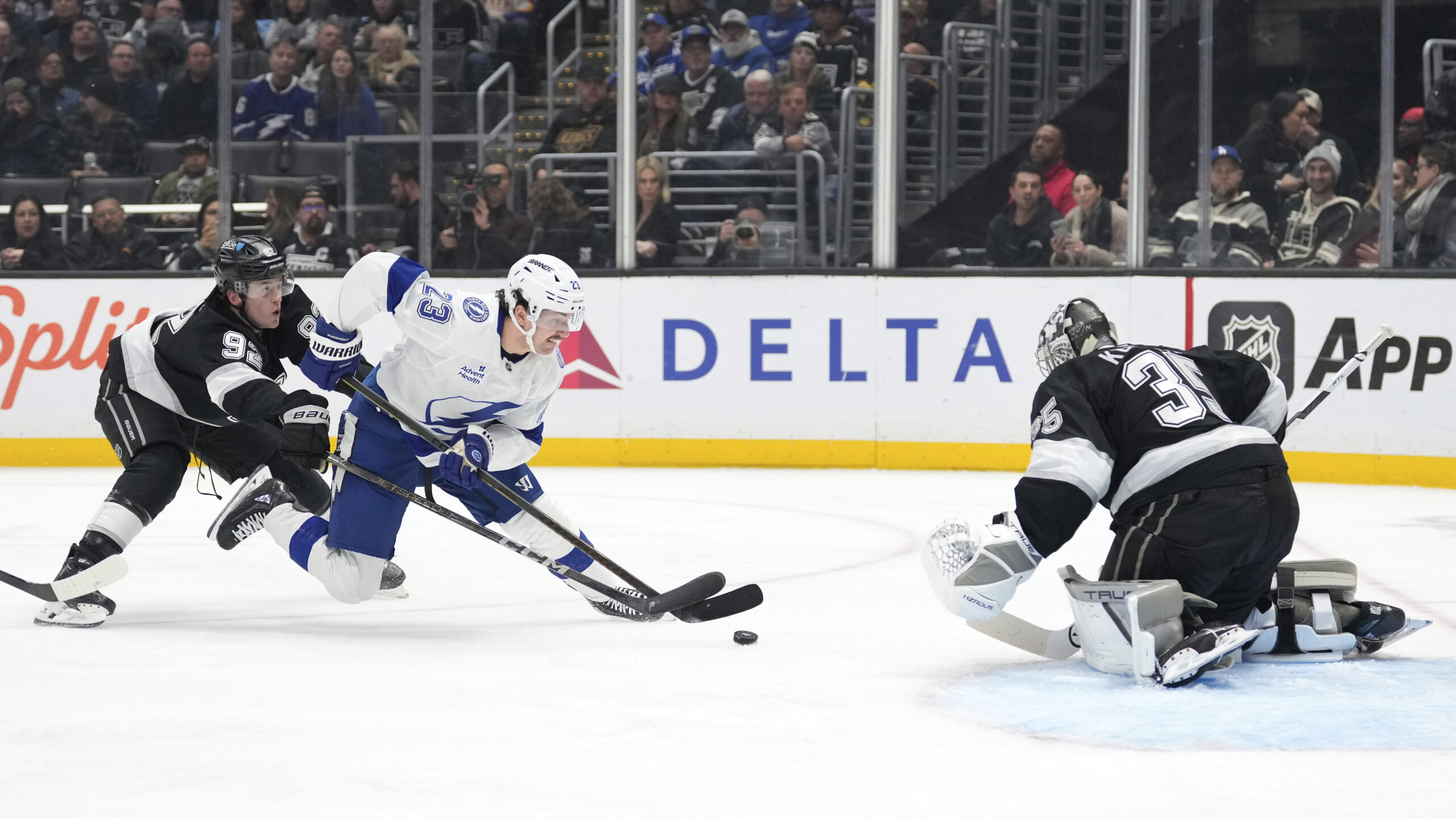 Tampa Bay Lightning center Michael Eyssimont, center, tries to score...