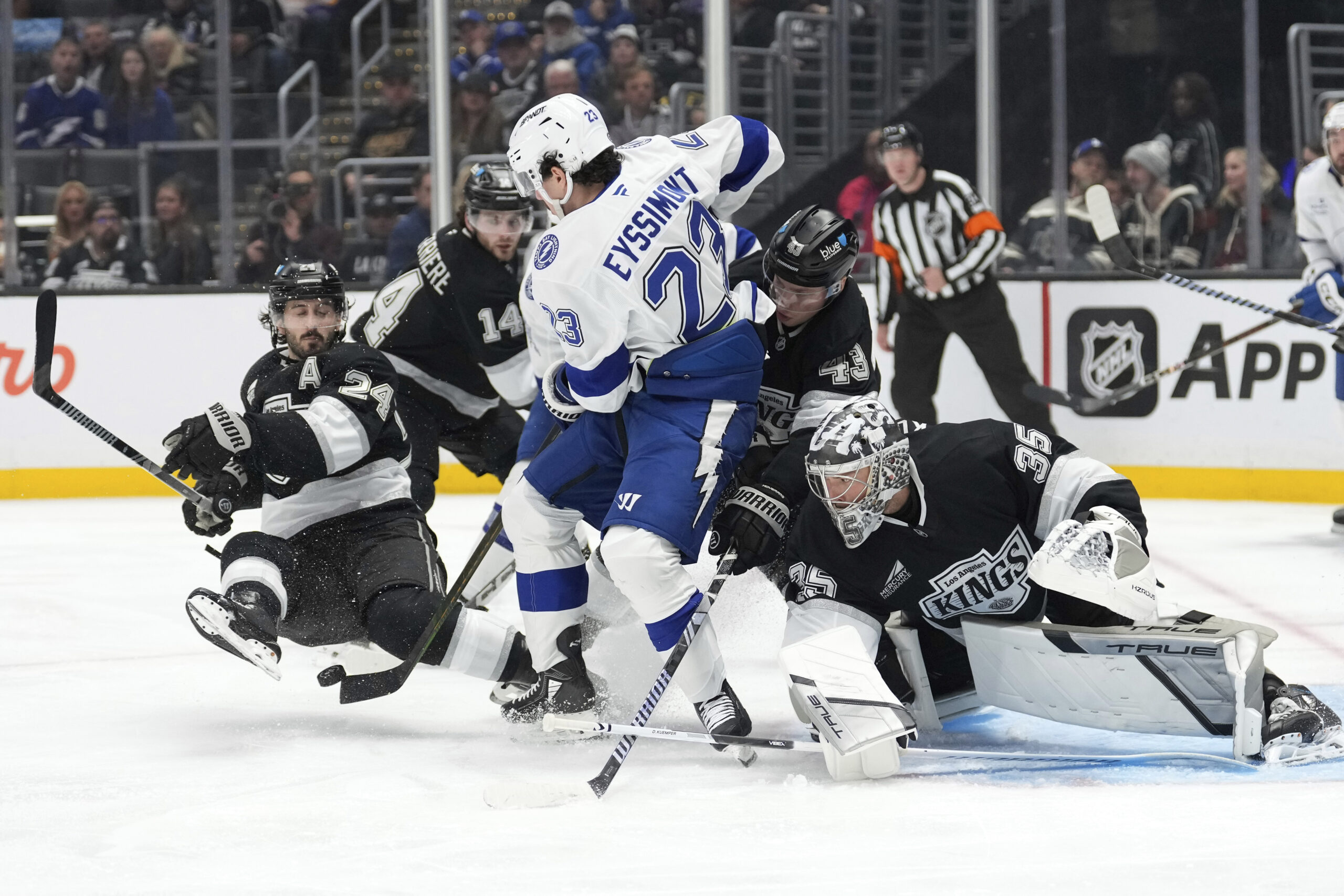 Kings goaltender Darcy Kuemper, right, deflects a shot by Tampa...