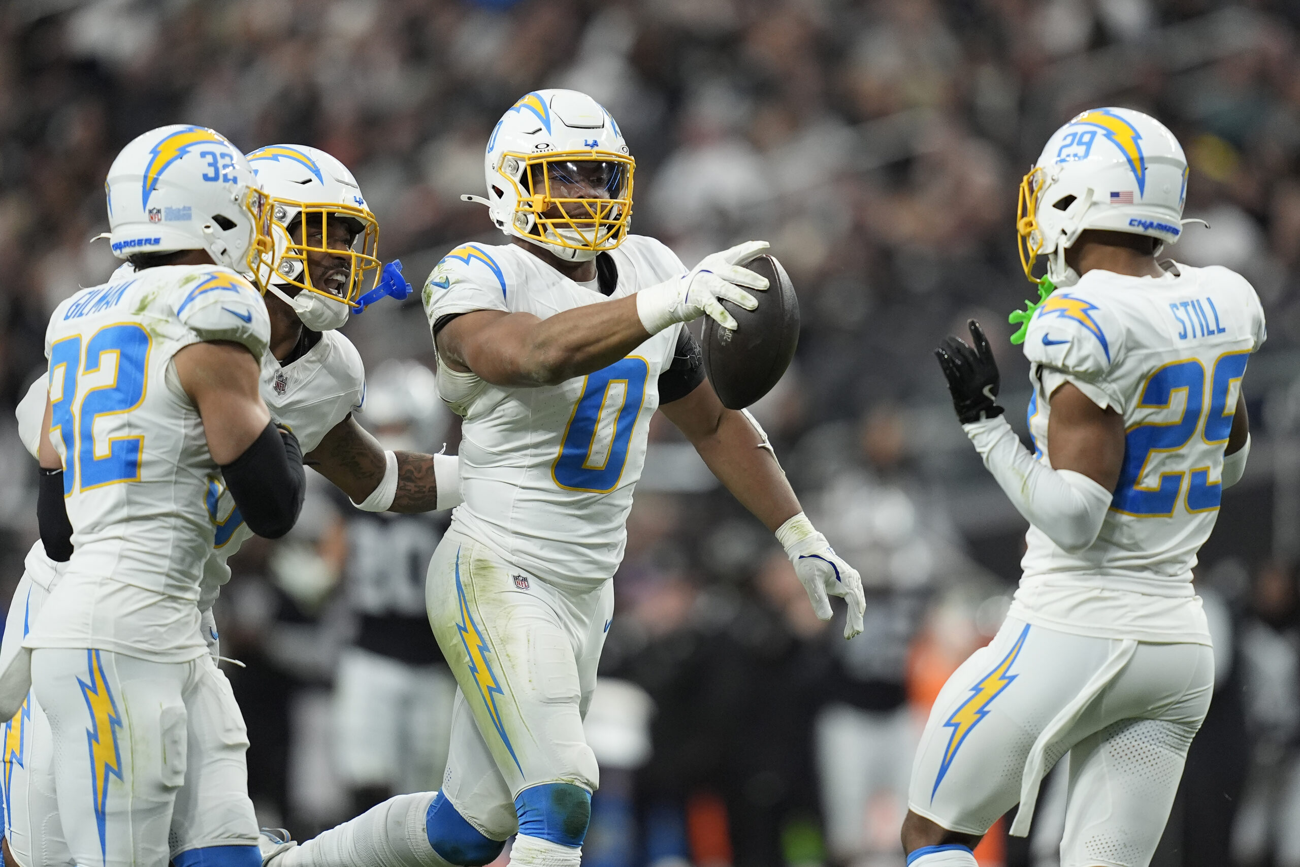 Los Angeles Chargers linebacker Daiyan Henley (0) celebrates with teammates...