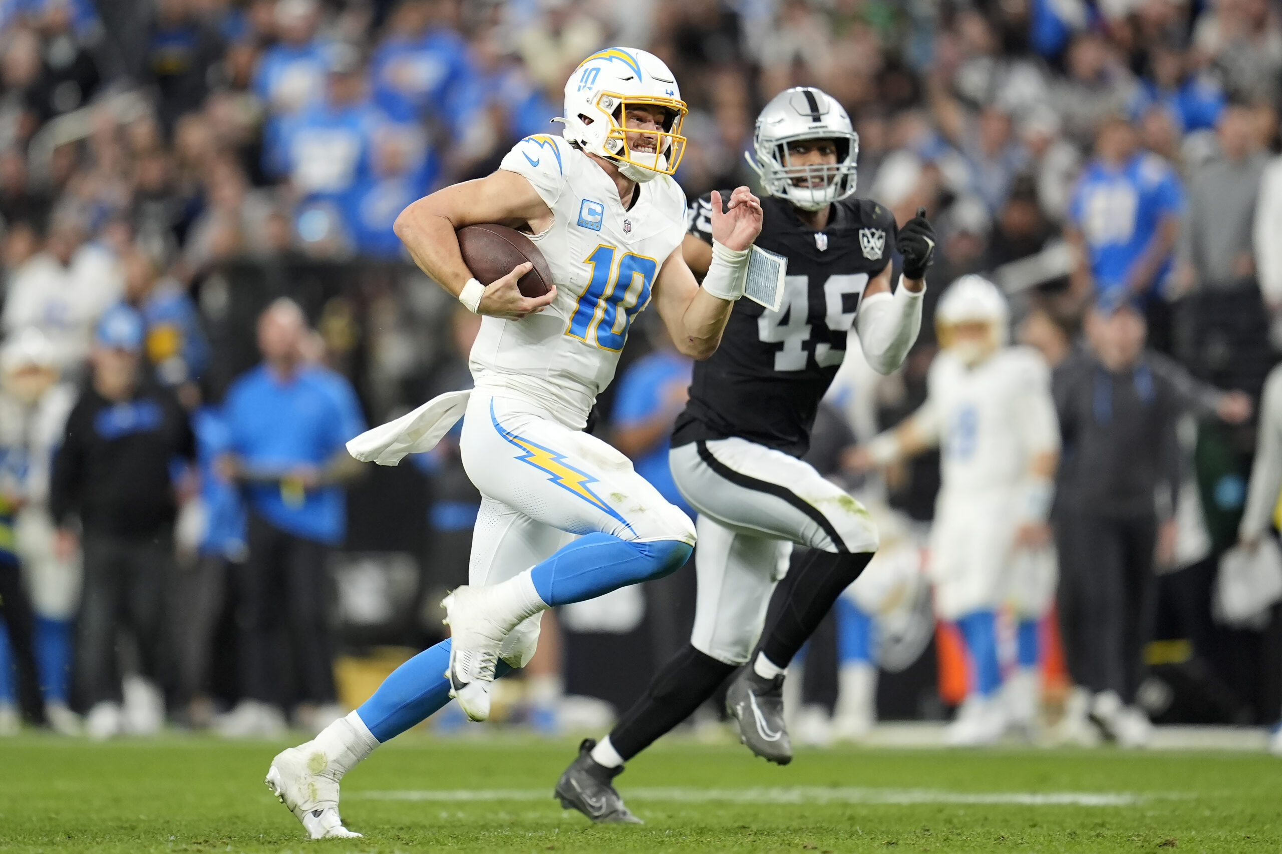 Los Angeles Chargers quarterback Justin Herbert (10) runs against Las...