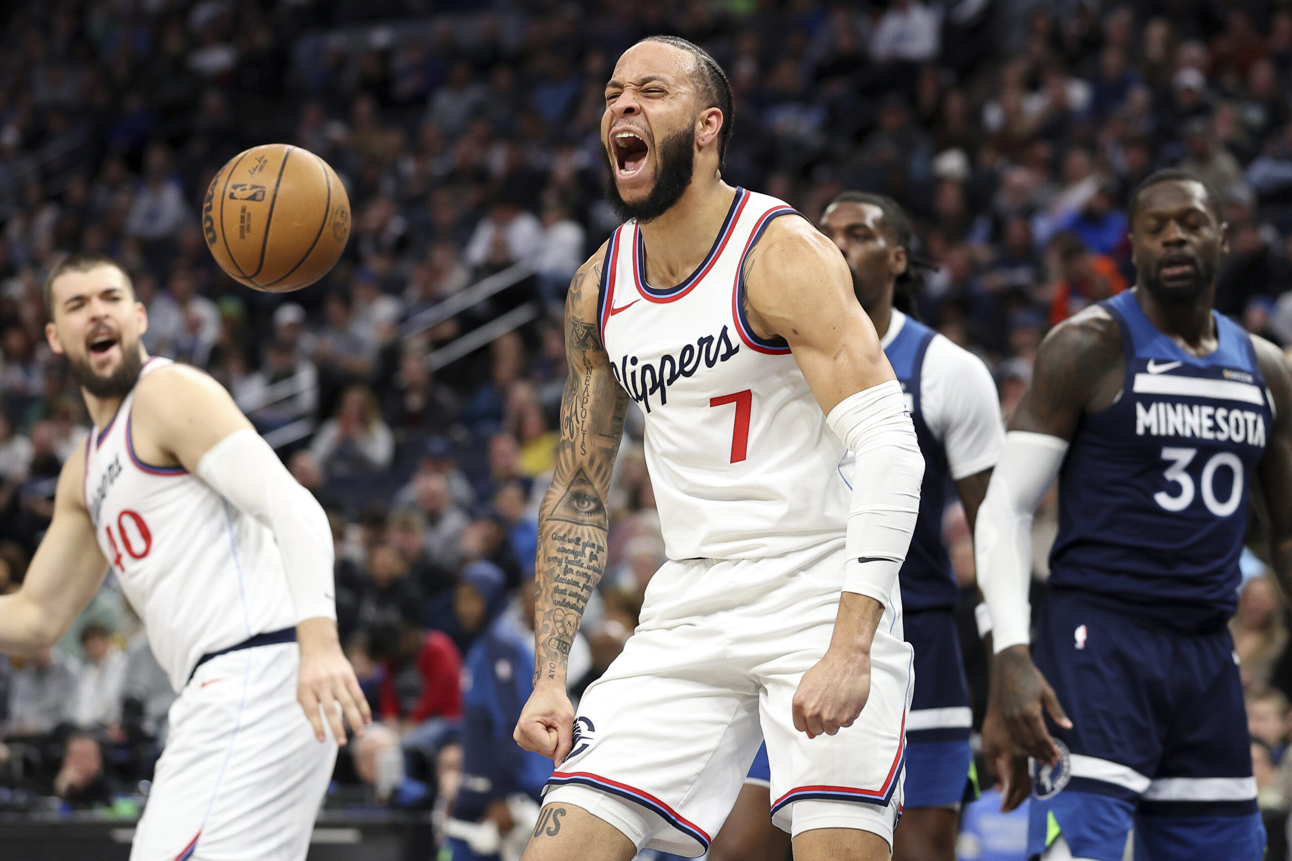 Clippers guard Amir Coffey celebrates his dunk during the first...