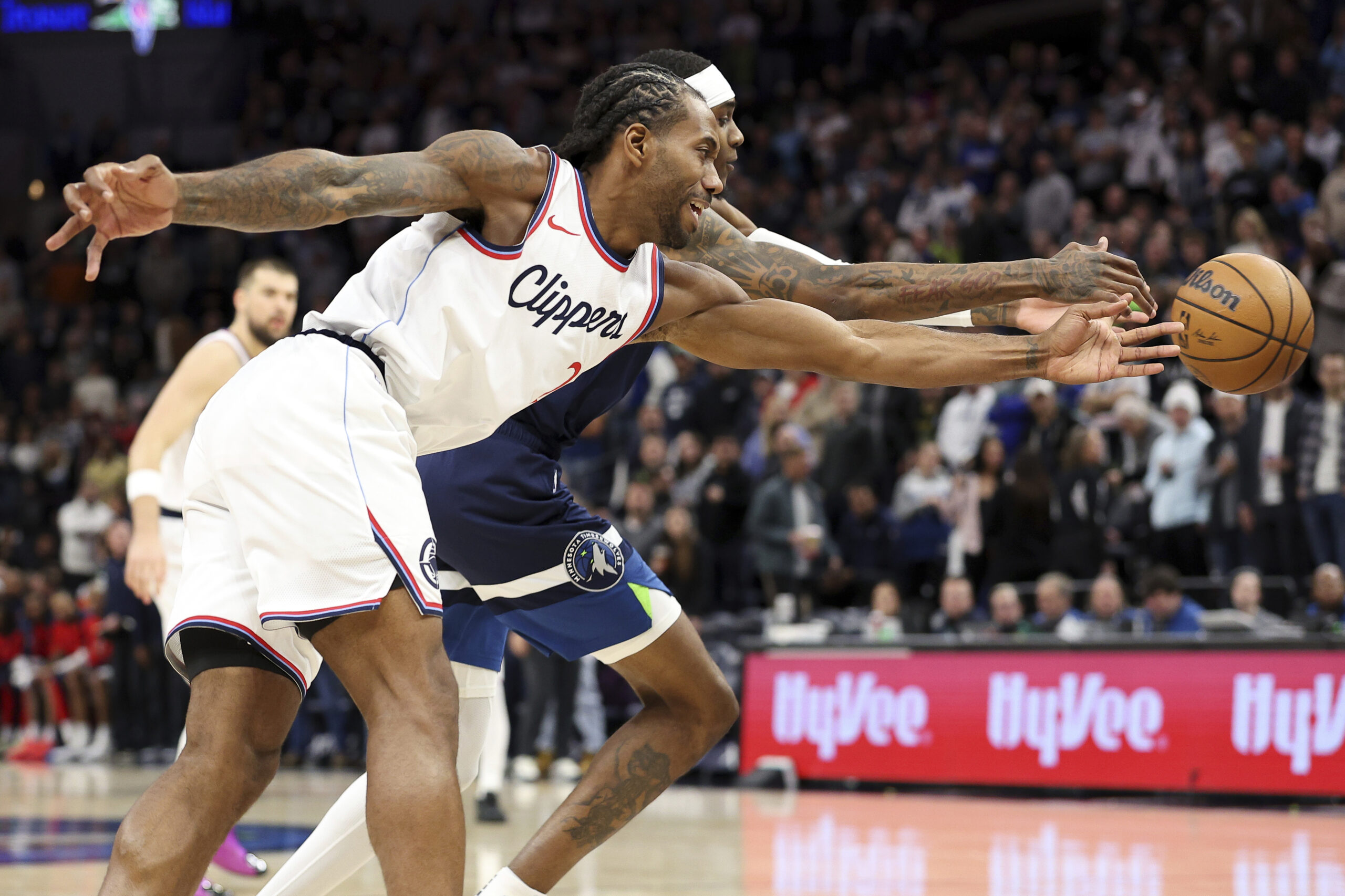 Clippers forward Kawhi Leonard, left, and Minnesota Timberwolves forward Jaden...