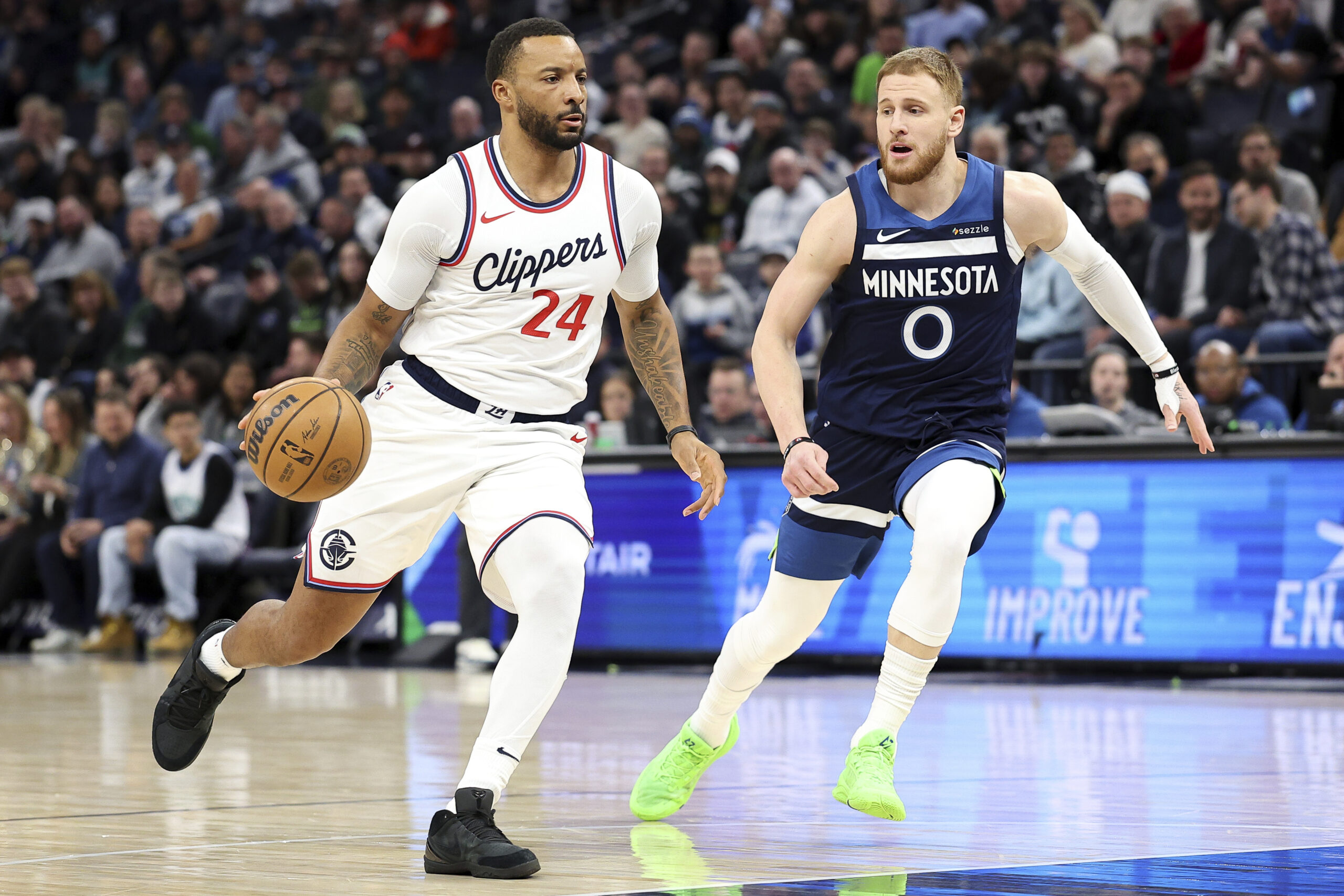 Clippers guard Norman Powell, left, handles the ball as Minnesota...