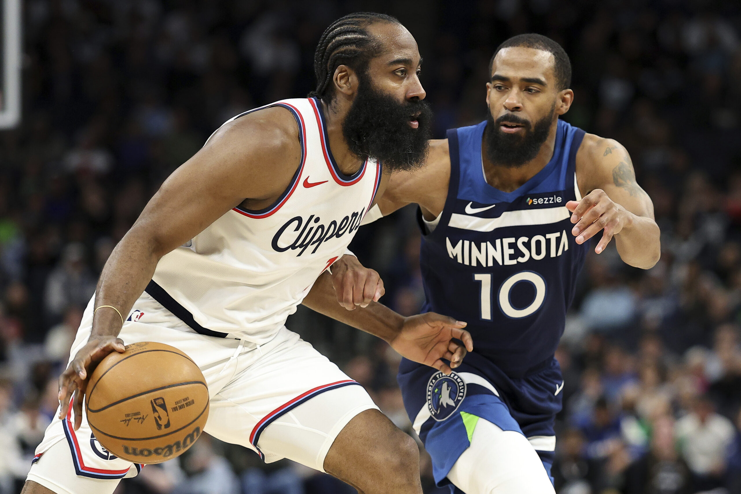 Clippers guard James Harden, left, drives as Minnesota Timberwolves guard...