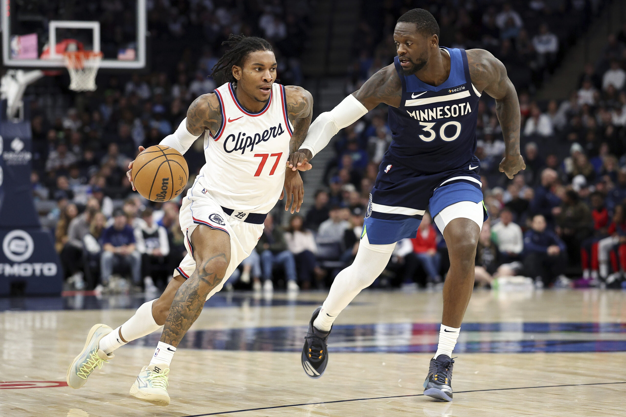 Clippers guard Kevin Porter Jr., left, drives as Minnesota Timberwolves...