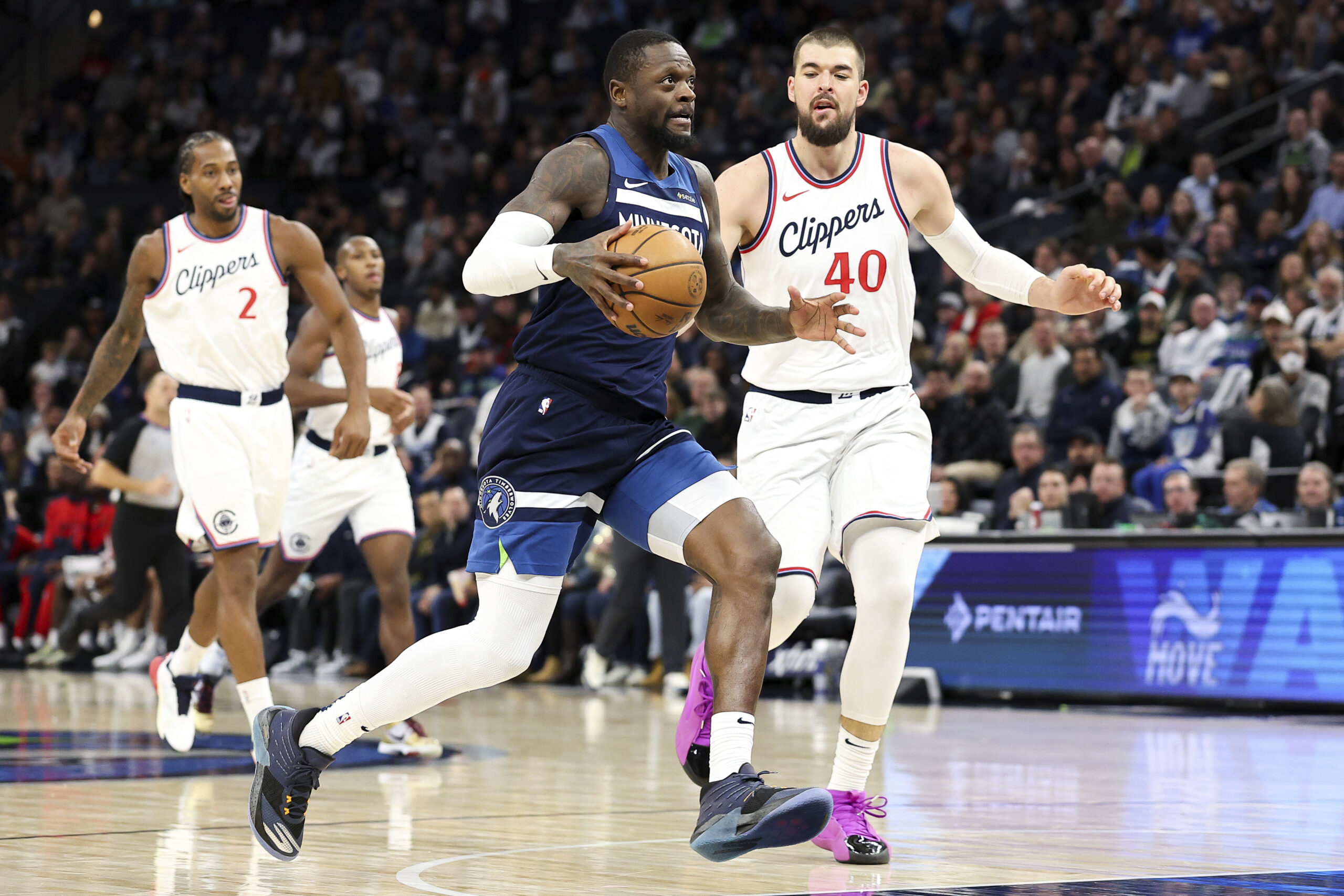 Minnesota Timberwolves forward Julius Randle, front left, drives toward the...