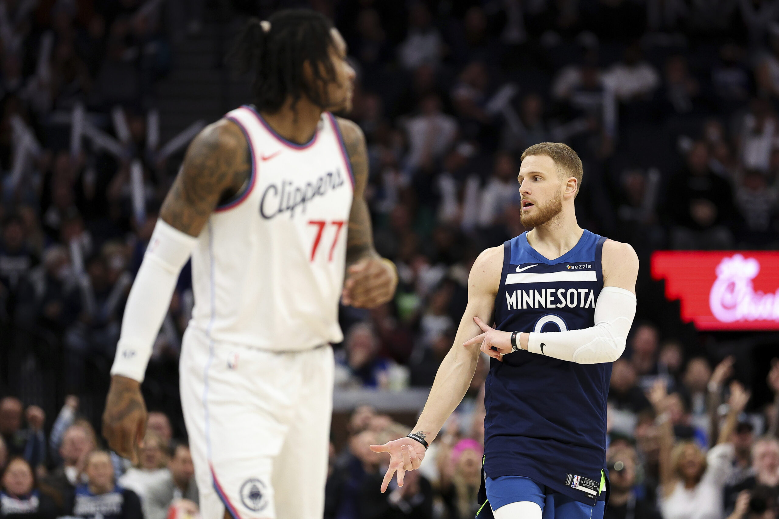 Minnesota Timberwolves guard Donte DiVincenzo, right, celebrates after making a...