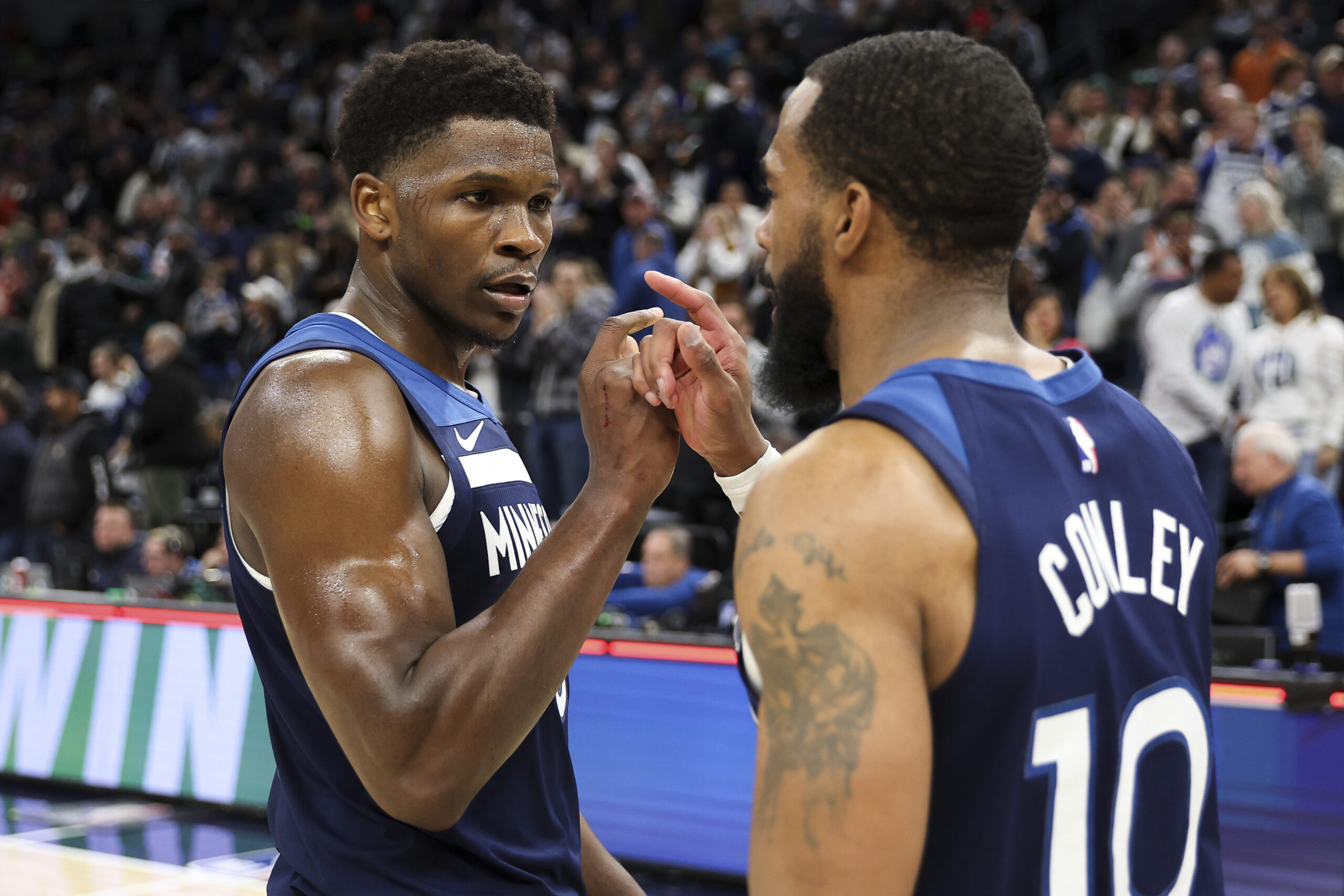 Minnesota Timberwolves guards Anthony Edwards, left, and Mike Conley celebrate...