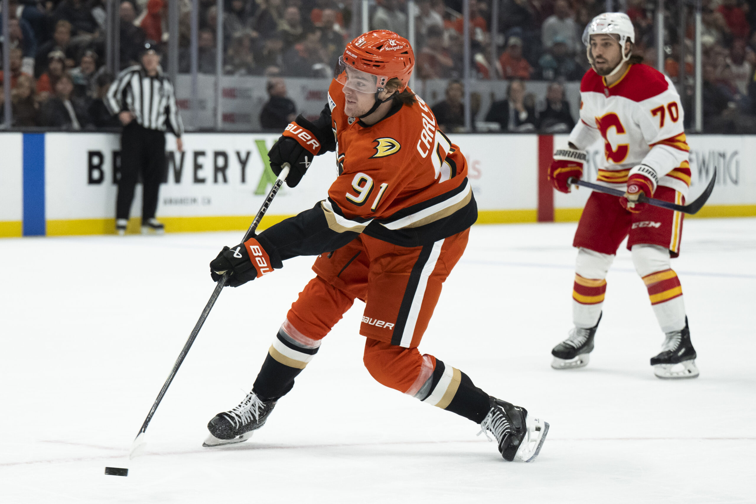 Ducks center Leo Carlsson shoots the puck as Calgary Flames...