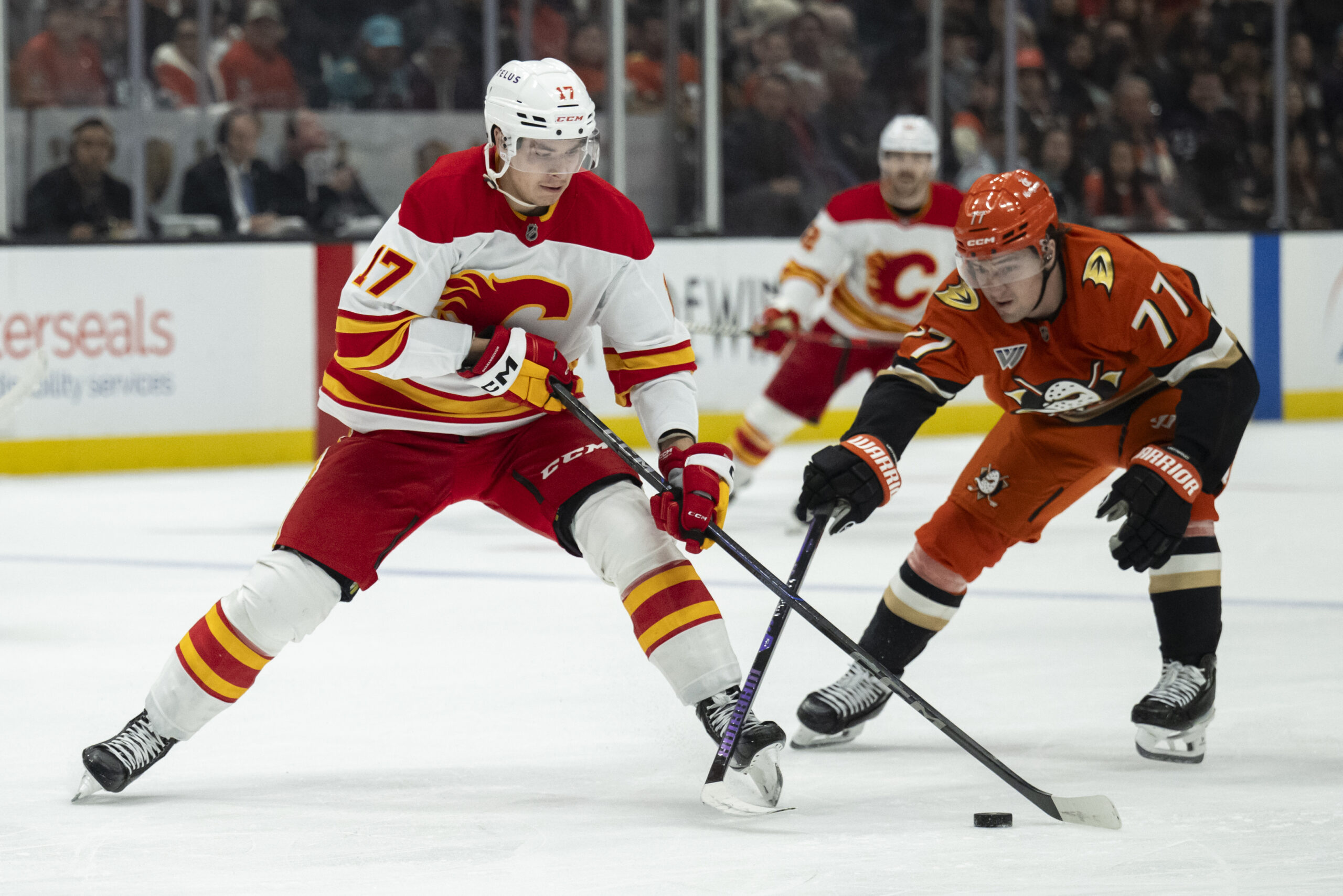 Calgary Flames center Yegor Sharangovich, left, controls the puck as...