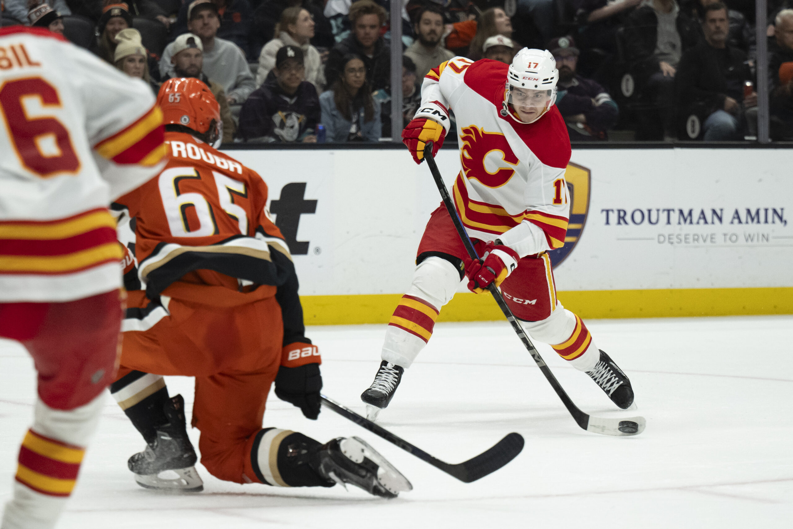 Calgary Flames center Yegor Sharangovich, right, shoots the puck as...