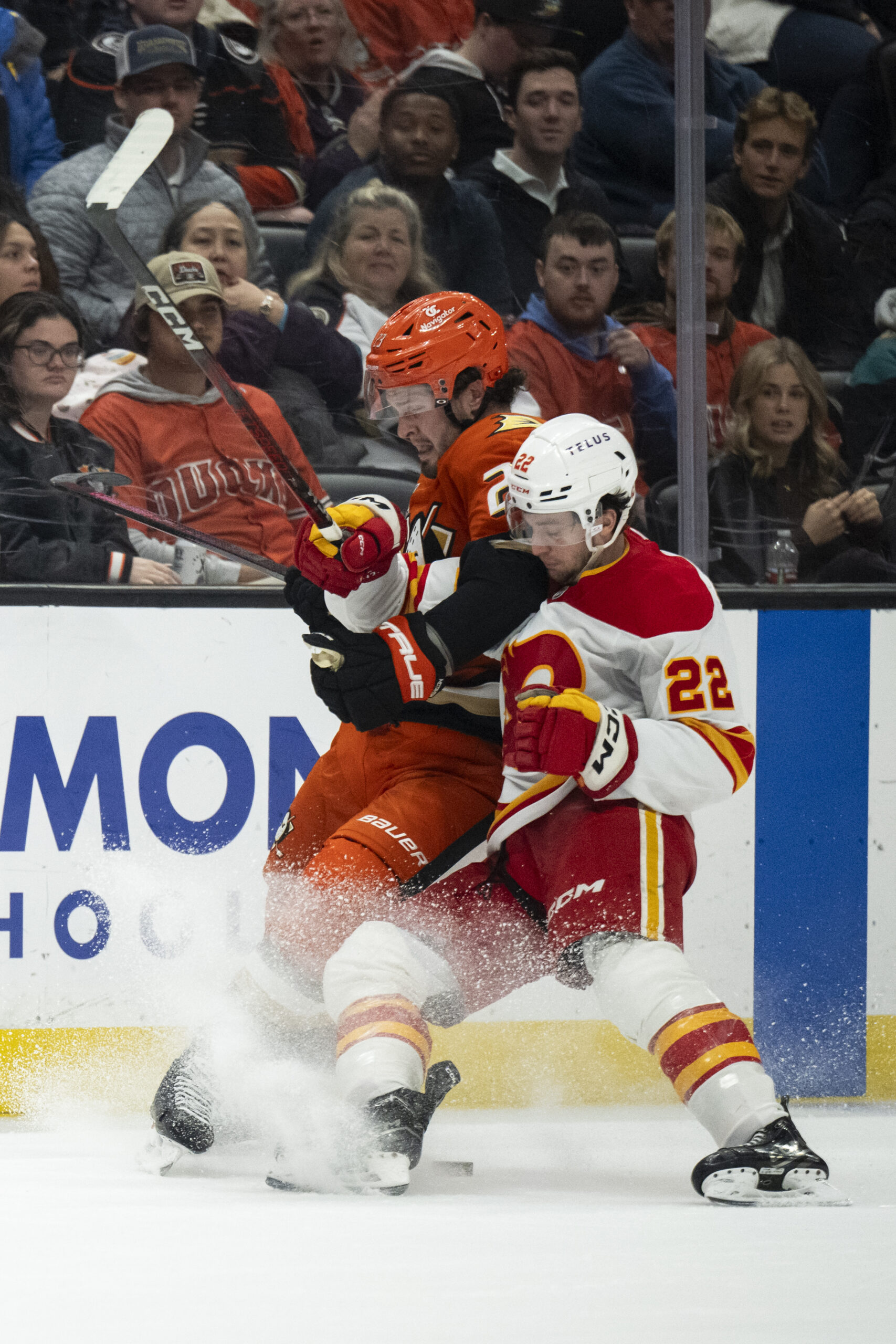 Ducks center Mason McTavish, left, and Calgary Flames left wing...