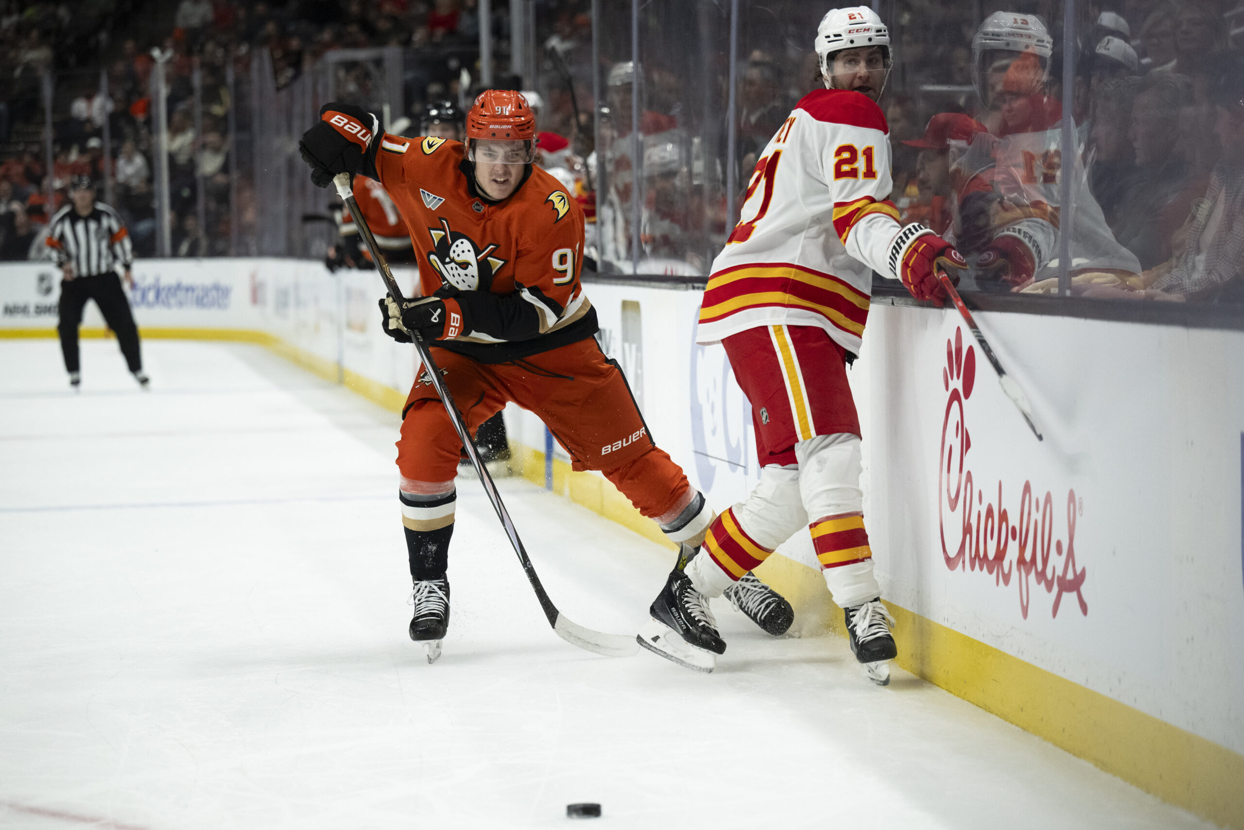 Ducks center Leo Carlsson, left, and Calgary Flames center Kevin...