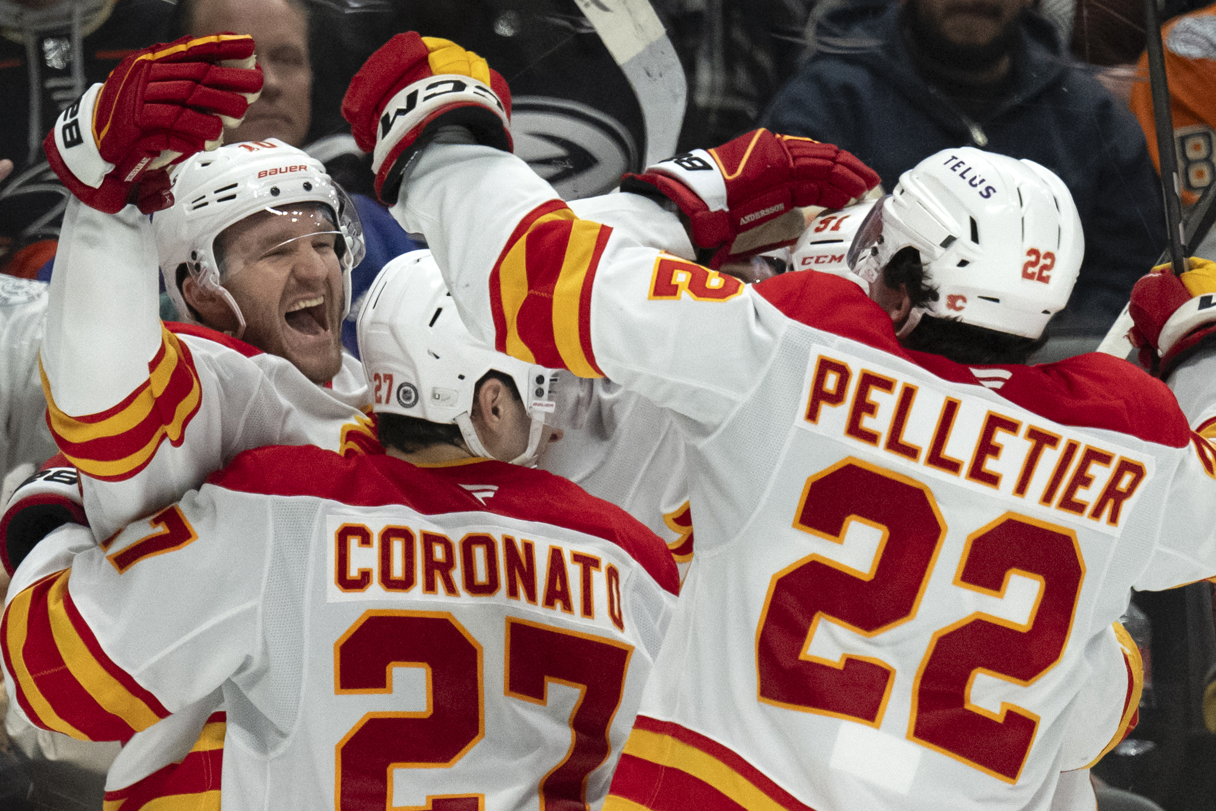 Calgary Flames players celebrate a game-winning overtime goal by center...