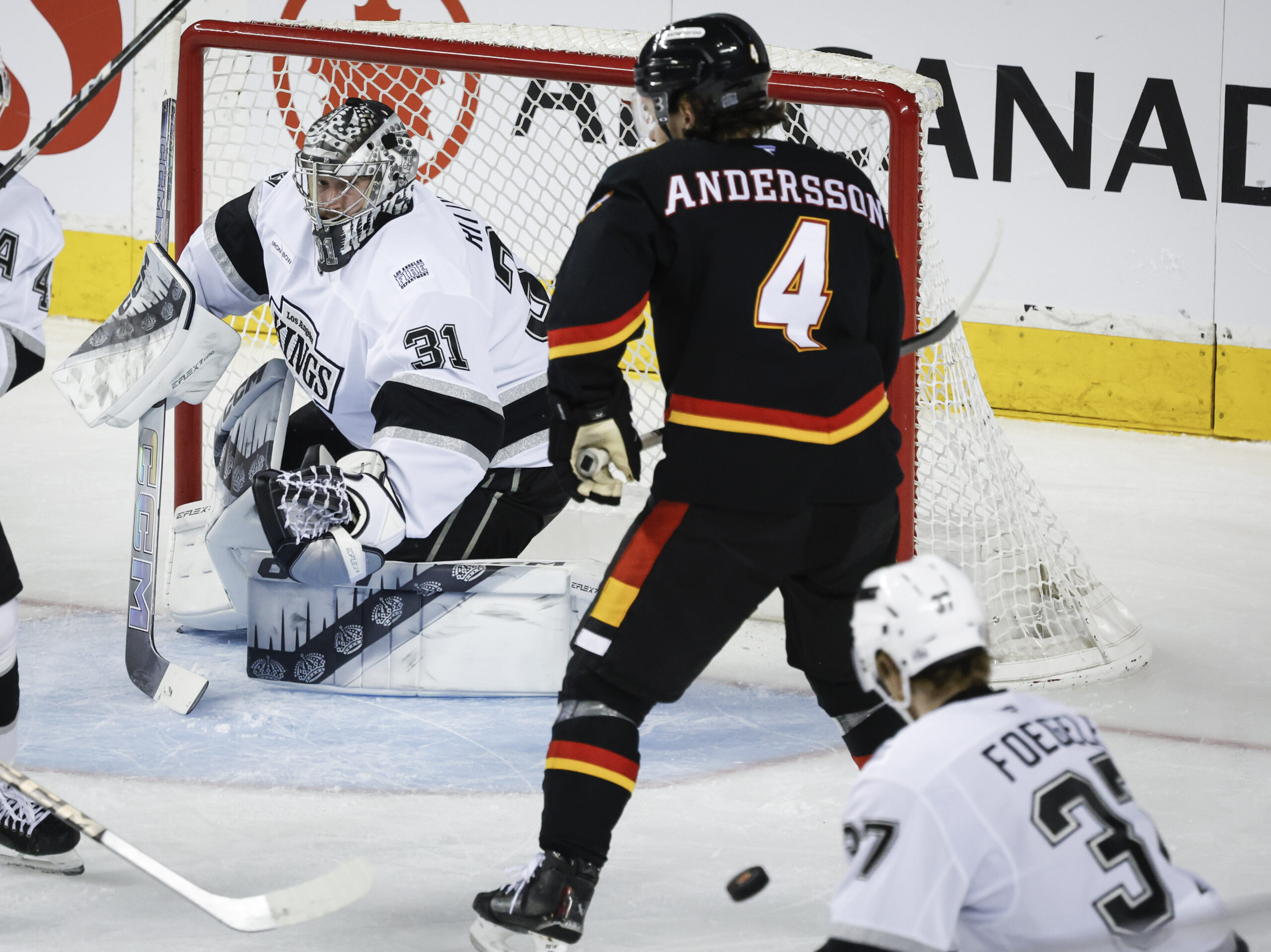 Kings’ goalie David Rittich, left, deflects a shot as Calgary...