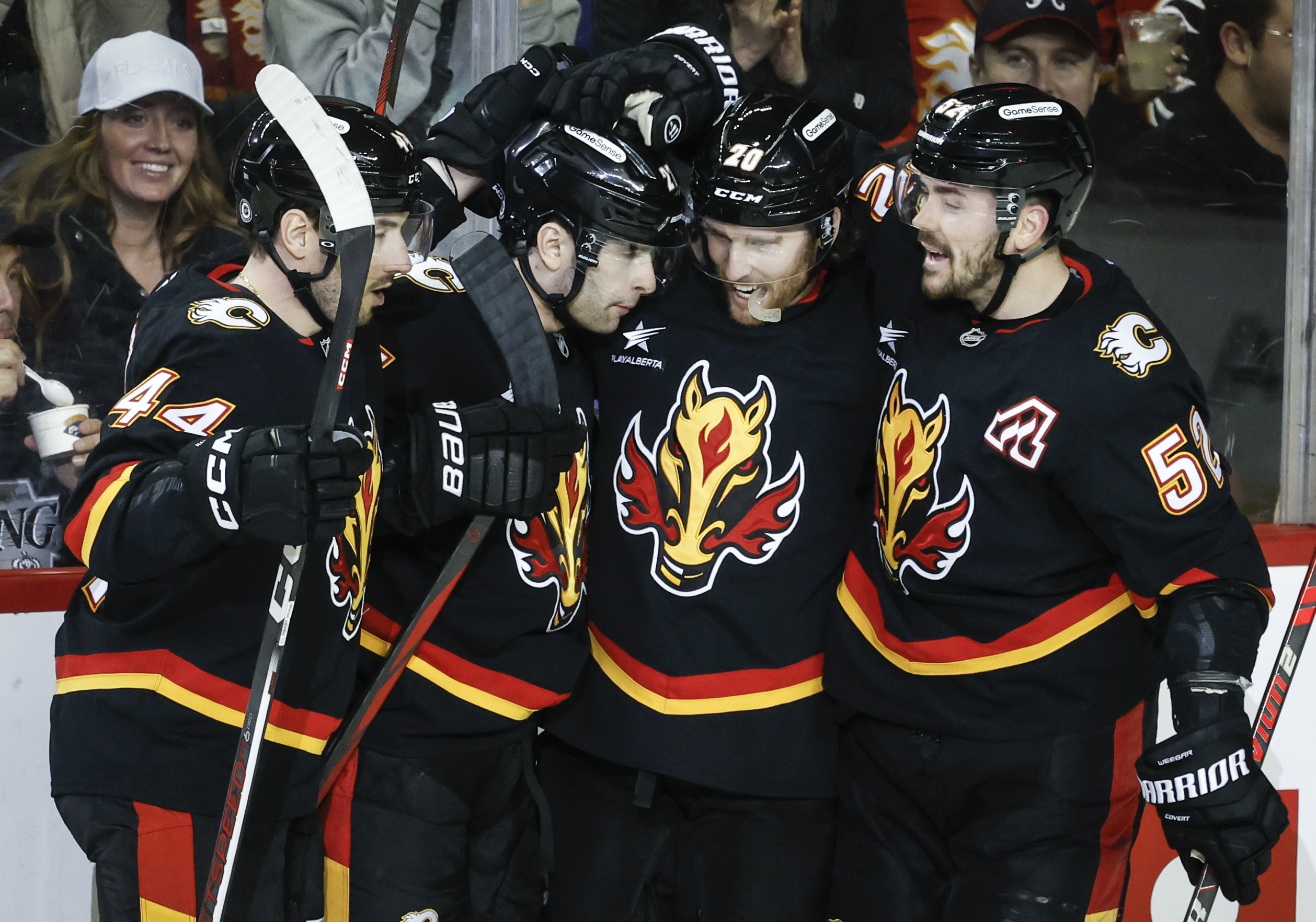 Calgary Flames’ Matthew Coronato, second left, celebrates his goal with...