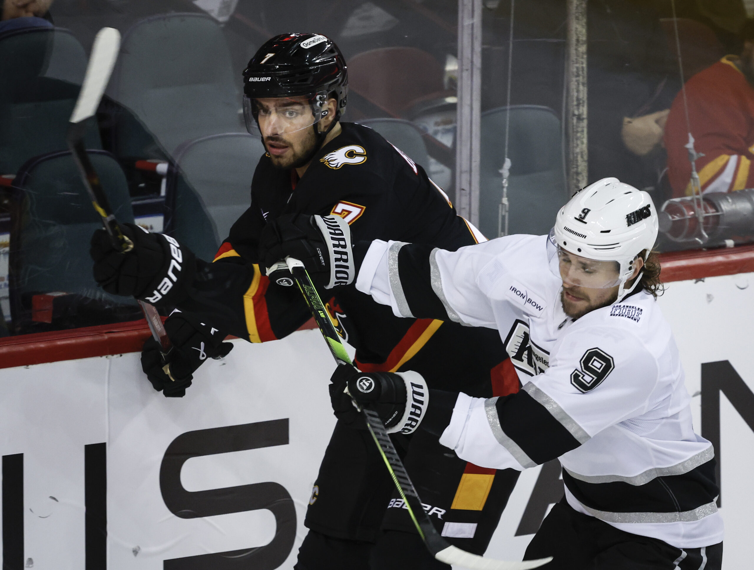 Kings’ Adrian Kempe, right, checks Calgary Flames’ Kevin Bahl, left,...