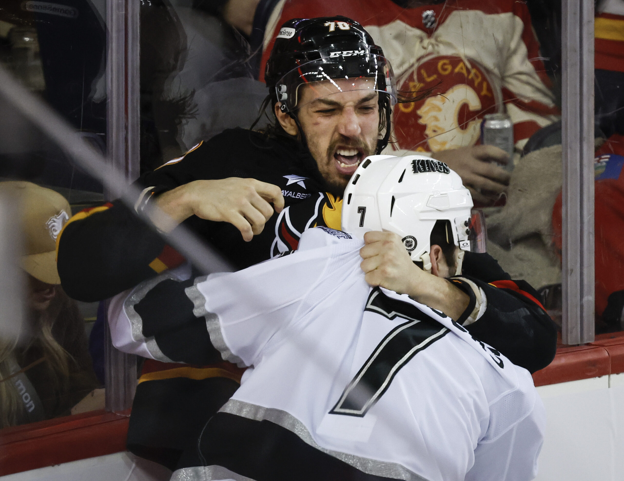 Kings’ Kyle Burroughs, right, fights with Calgary Flames’ Ryan Lomberg...