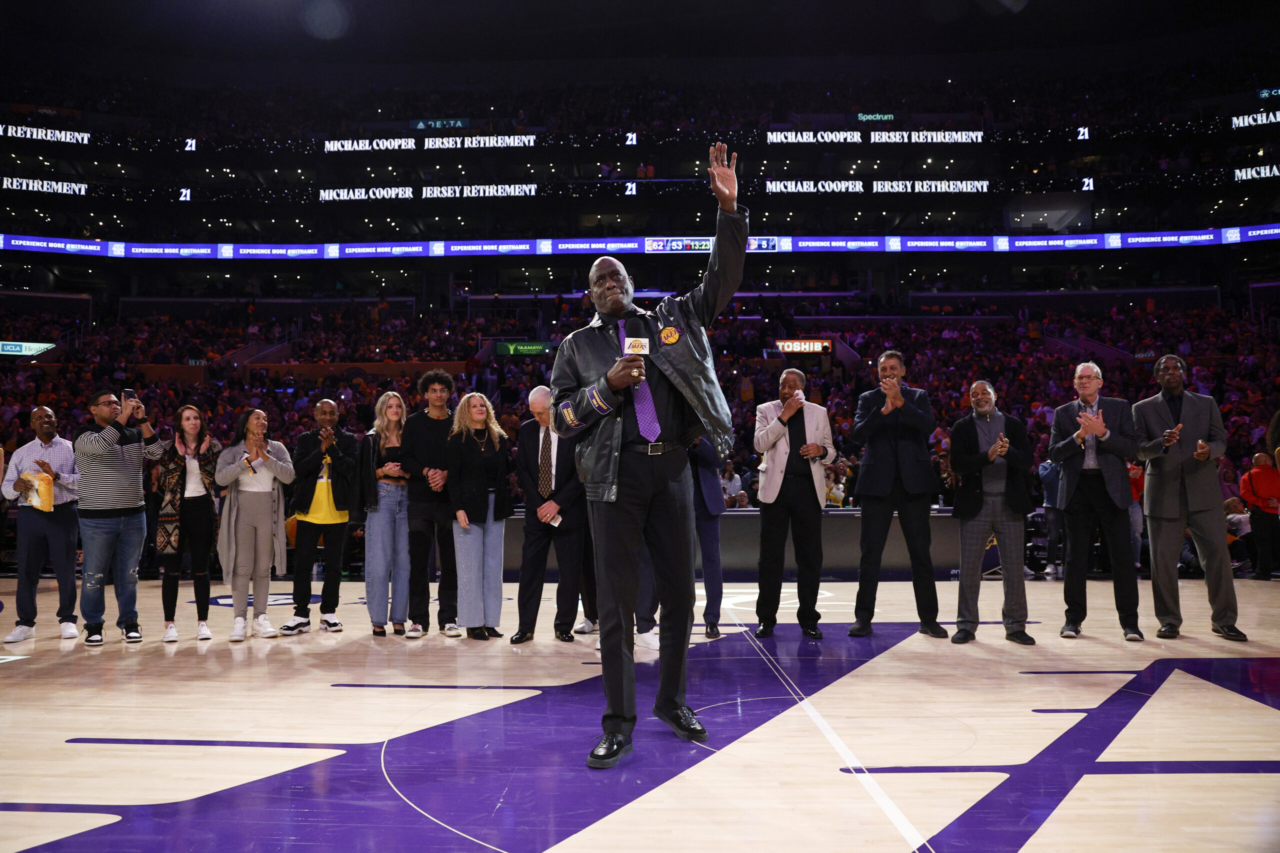 Former Lakers star Michael Cooper waves during his jersey retirement...