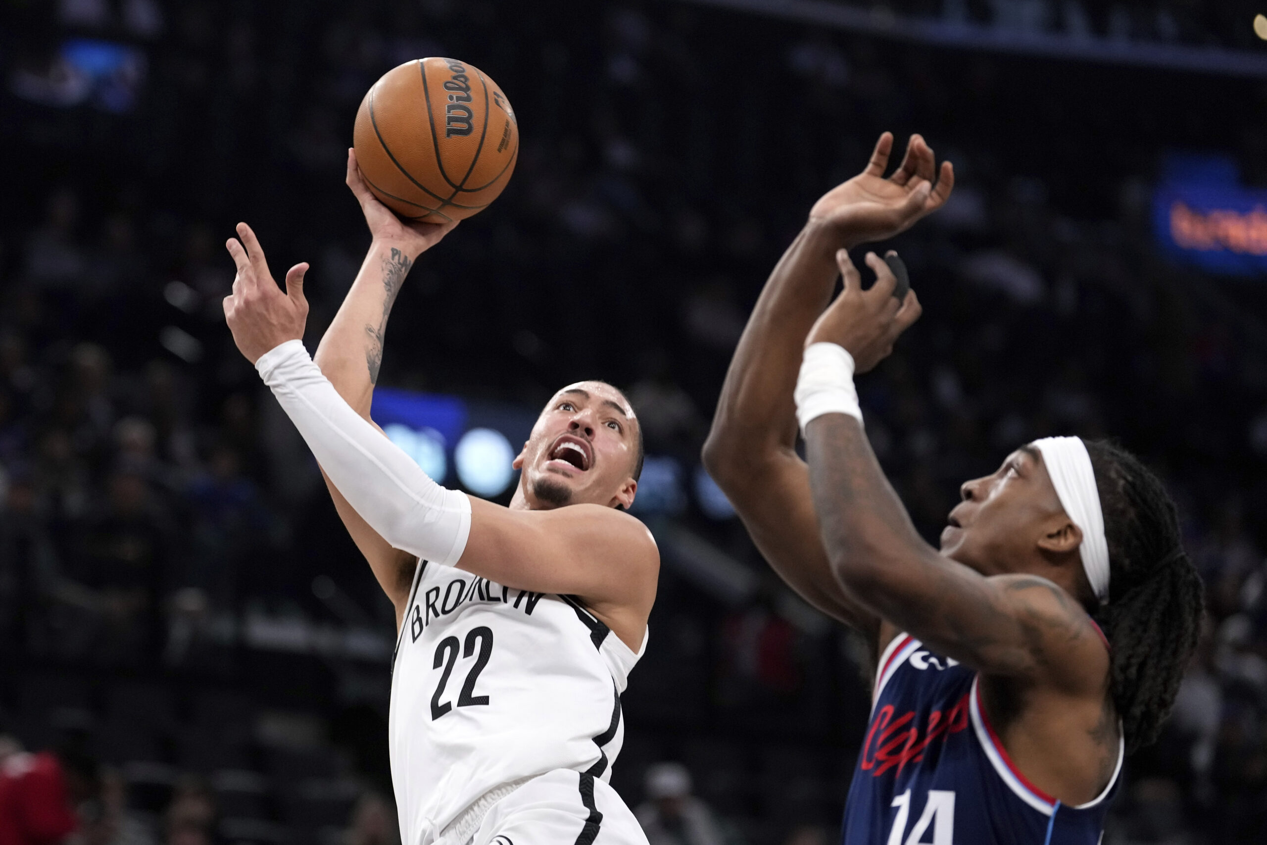 Brooklyn Nets forward Jalen Wilson, left, shoots as Clippers guard...