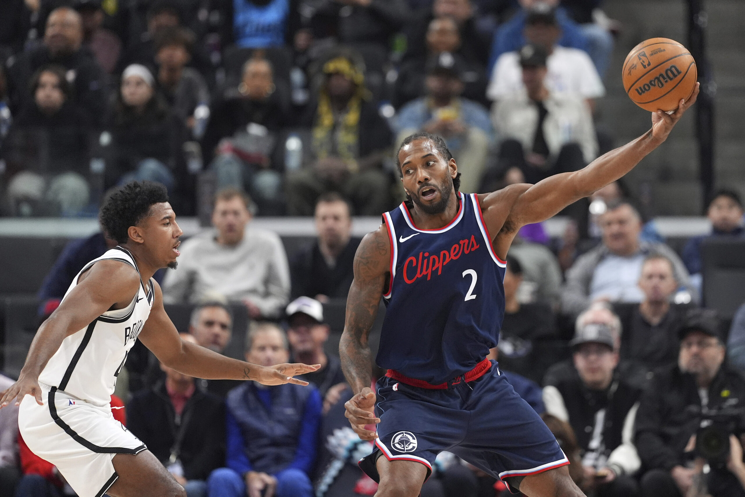 Clippers star Kawhi Leonard receives a pass as Brooklyn Nets...