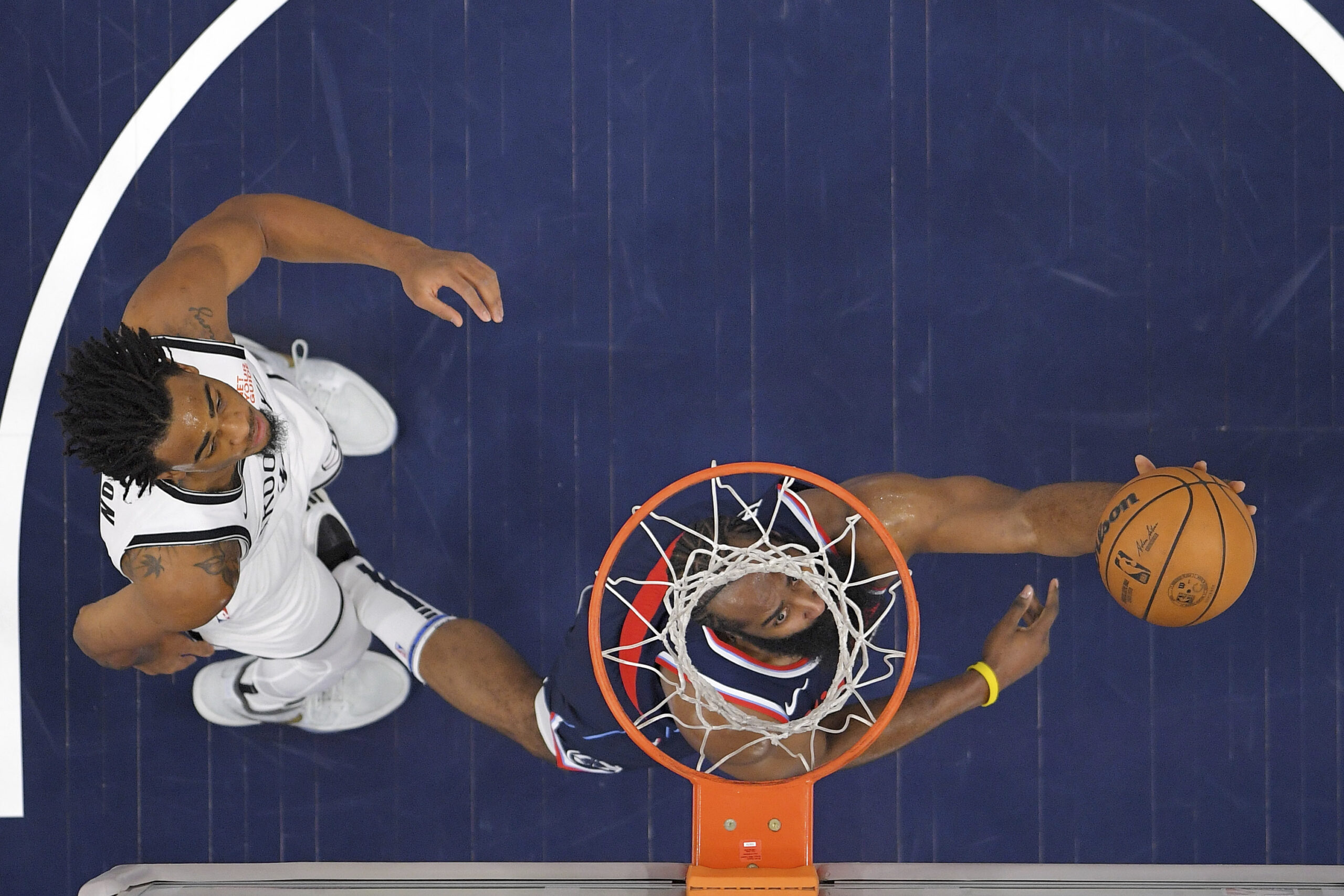 Clippers guard James Harden, right, shoots as Brooklyn Nets center...