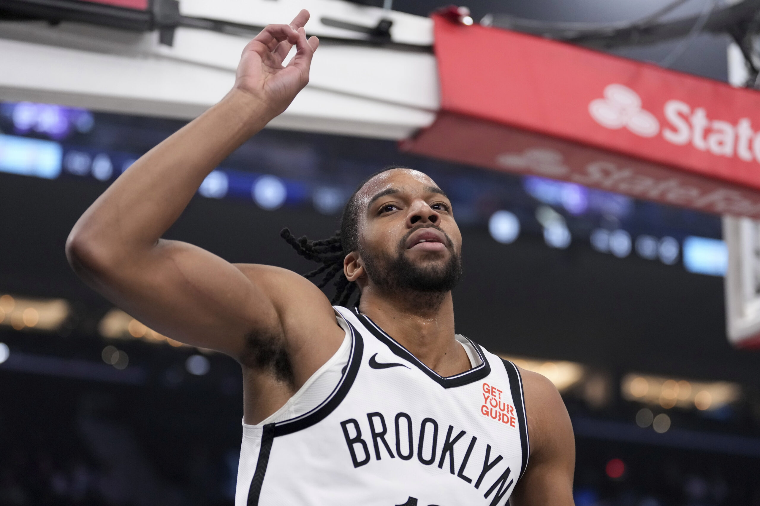 Brooklyn Nets forward Tosan Evbuomwan gestures after scoring during the...