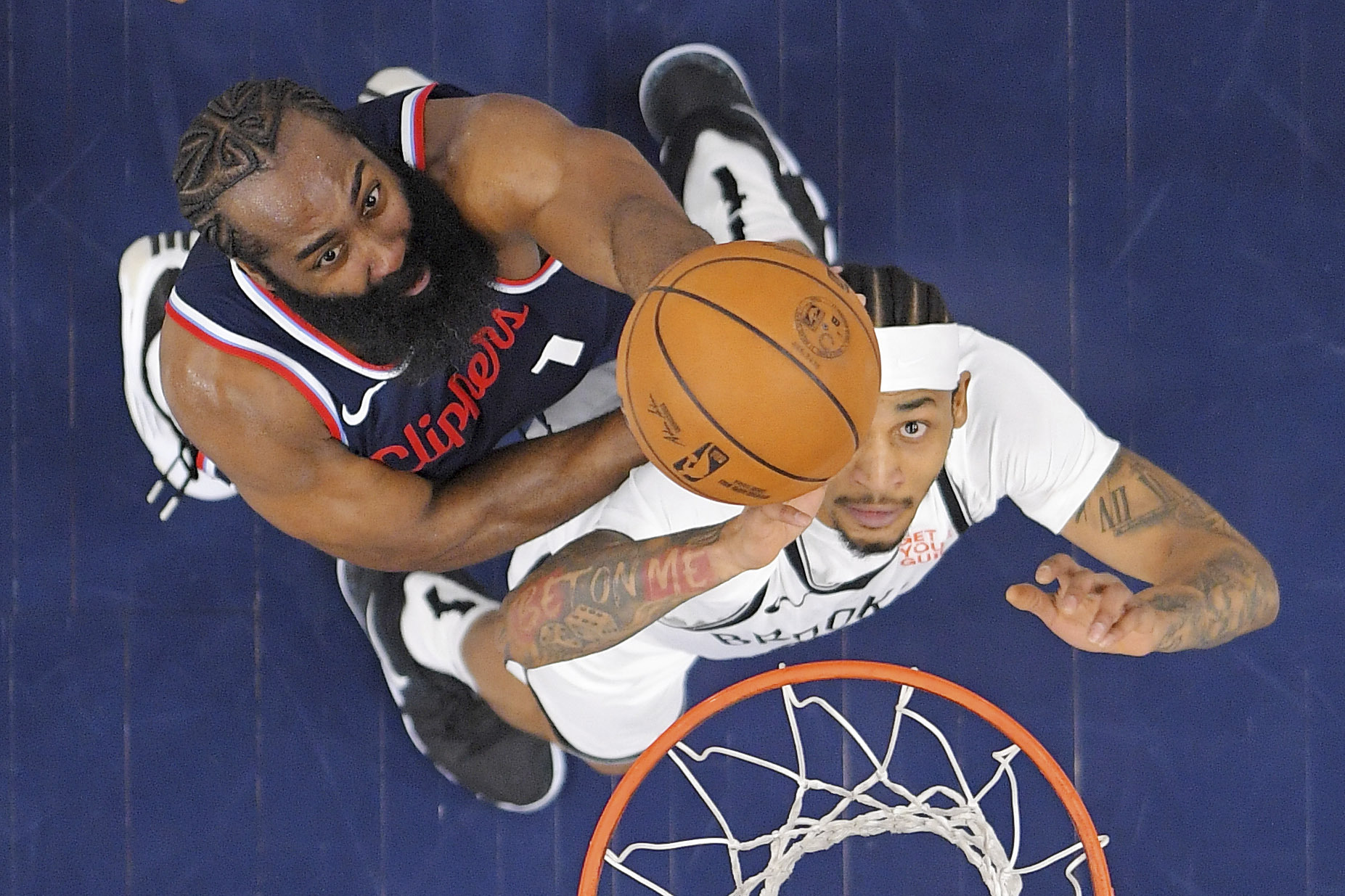 Clippers guard James Harden, left, and Brooklyn Nets guard Keon...