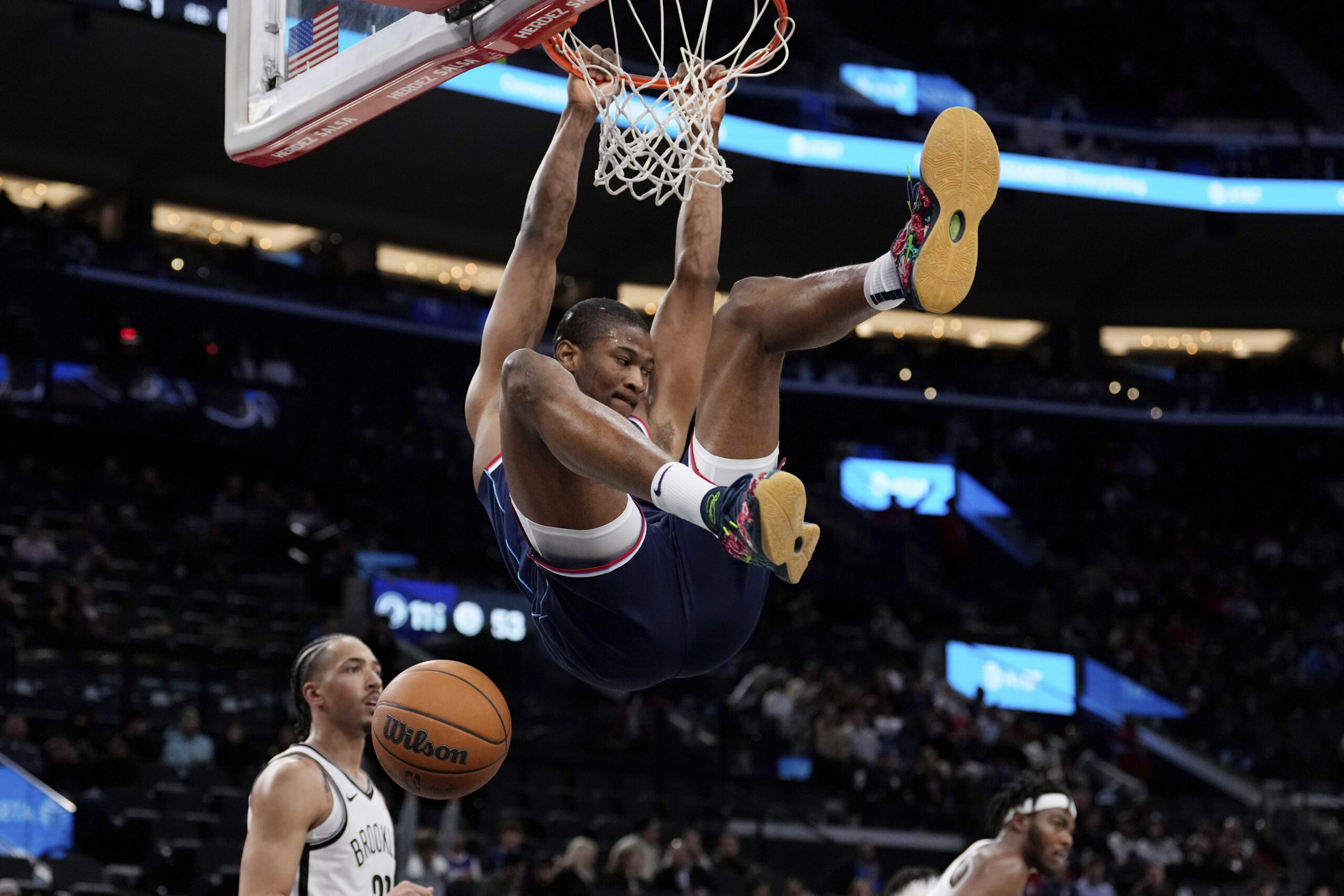 Clippers forward Kai Jones, center, dunks as Brooklyn Nets forward...