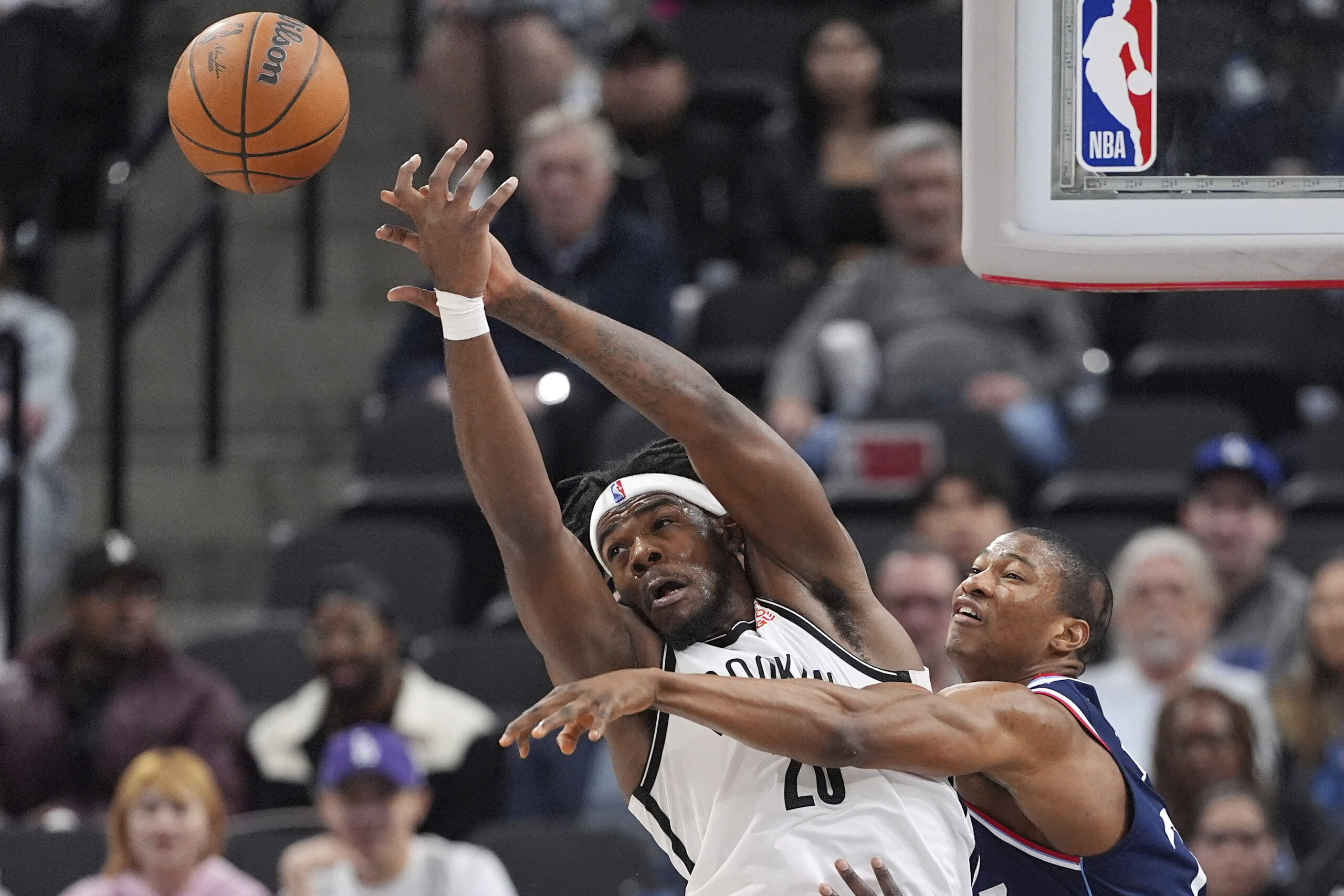 Brooklyn Nets center Day’Ron Sharpe, left, and Clippers forward Kai...