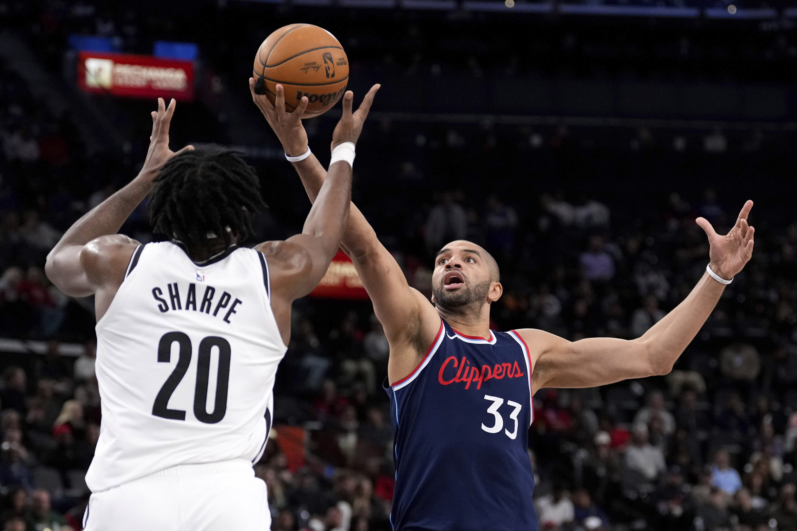 Brooklyn Nets center Day’Ron Sharpe, left, and Clippers forward Nicolas...