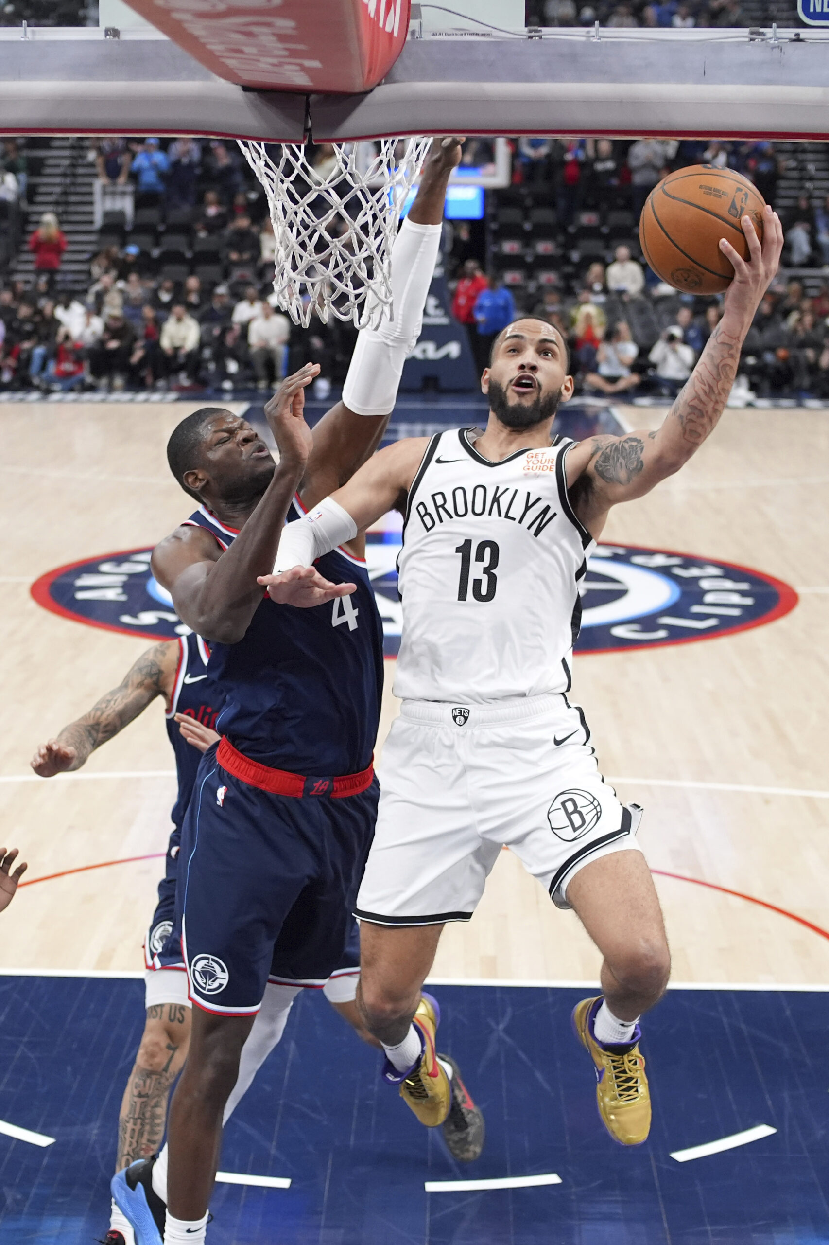 Brooklyn Nets guard Tyrese Martin, right, shoots as Clippers center...