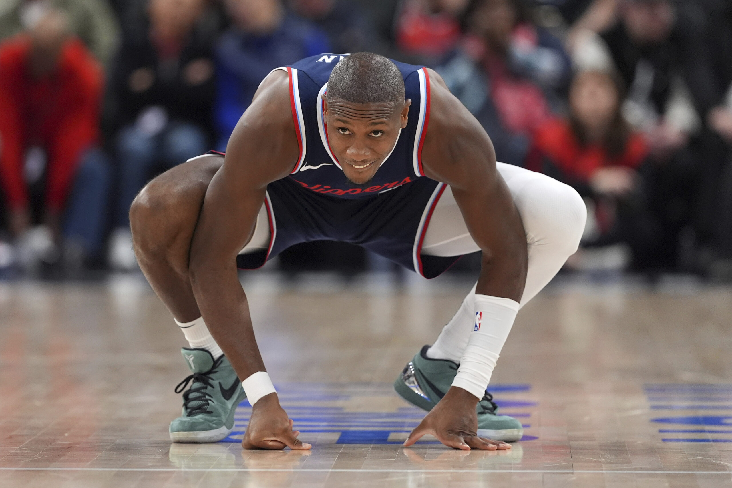 Clippers guard Kris Dunn stretches as he enters the game...