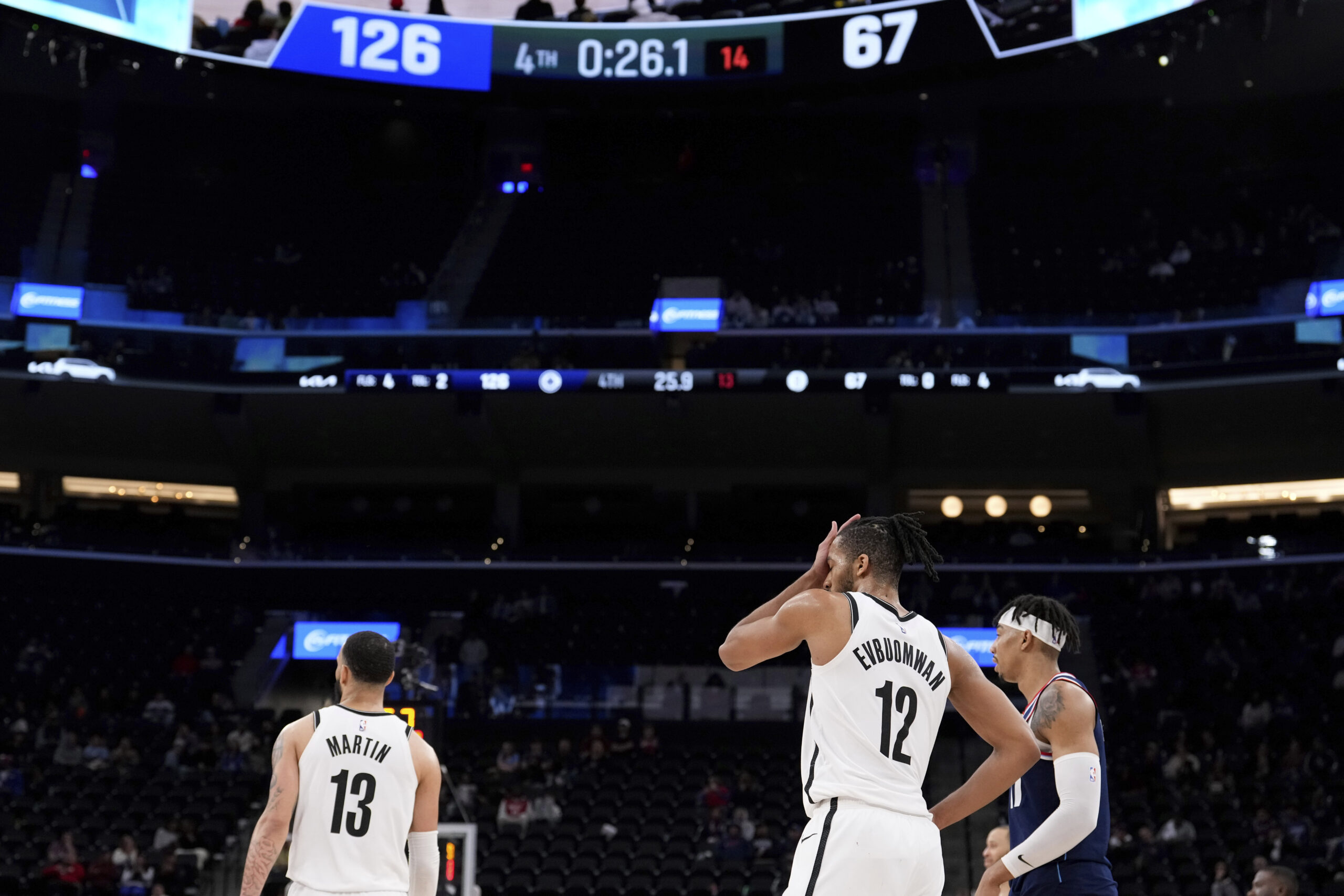 Brooklyn Nets guard Tyrese Martin,left, and forward Tosan Evbuomwan, center,...