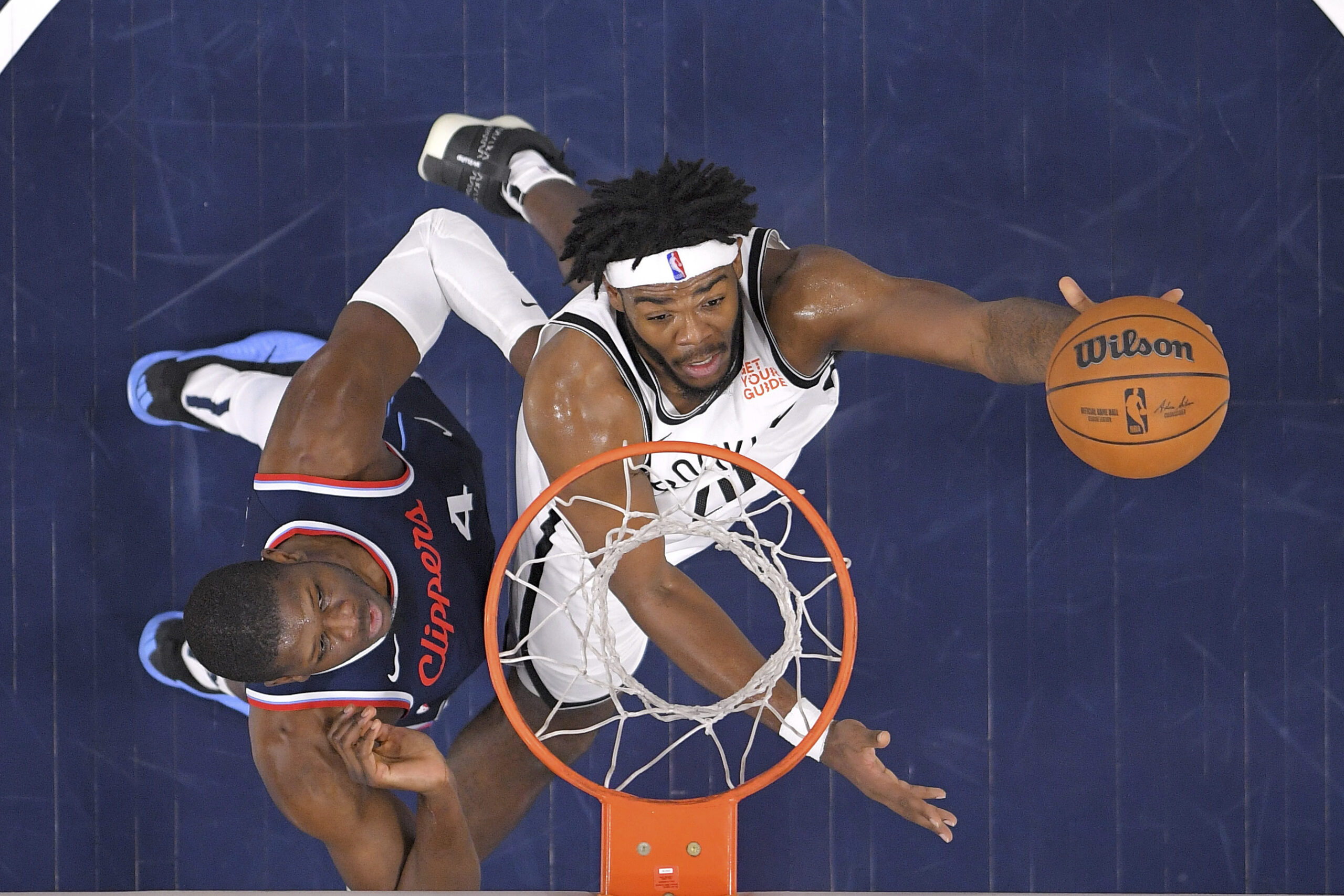 Brooklyn Nets center Day’Ron Sharpe, right, shoots as Clippers center...