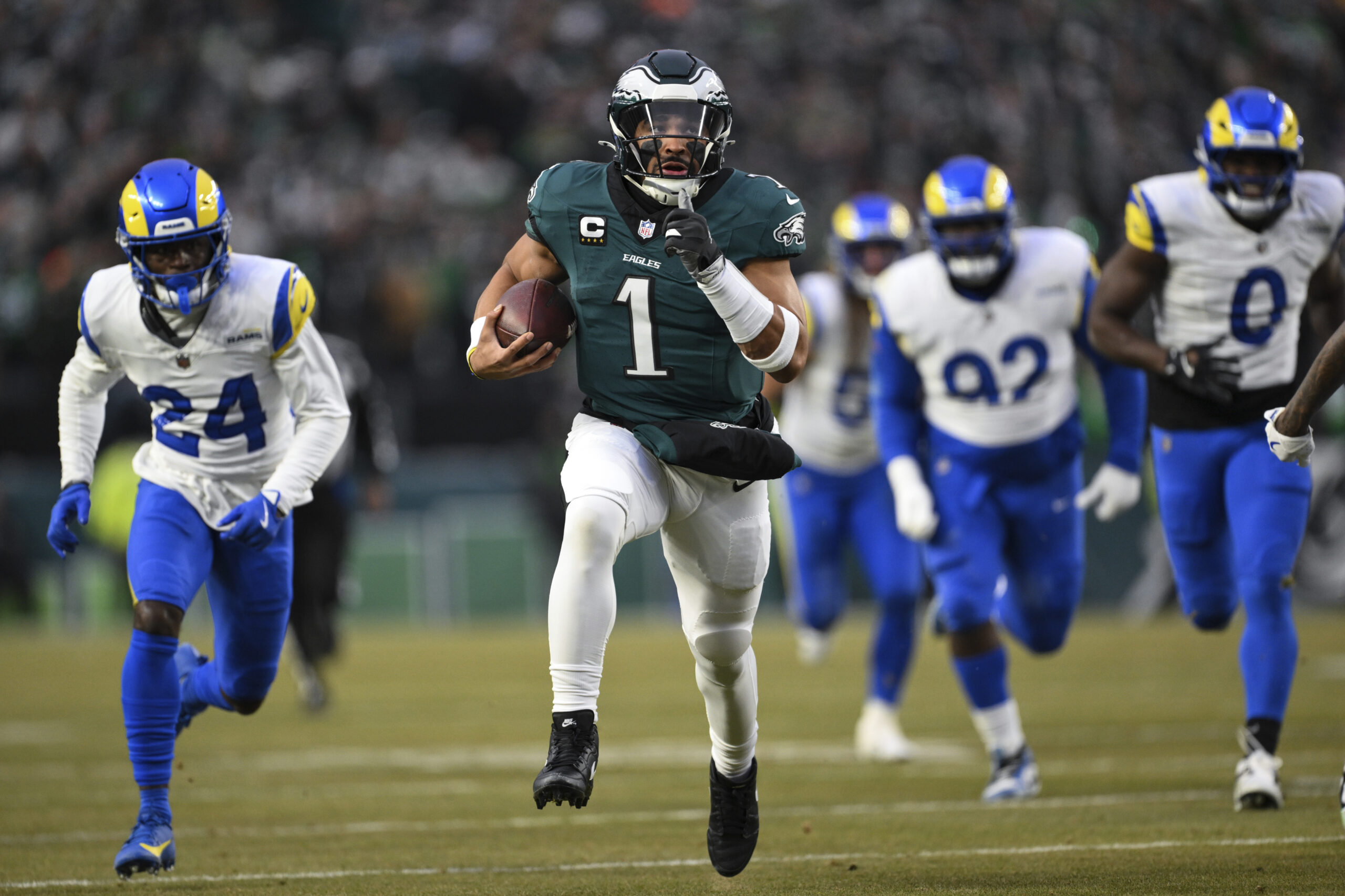 Philadelphia Eagles quarterback Jalen Hurts (1) runs the ball for...