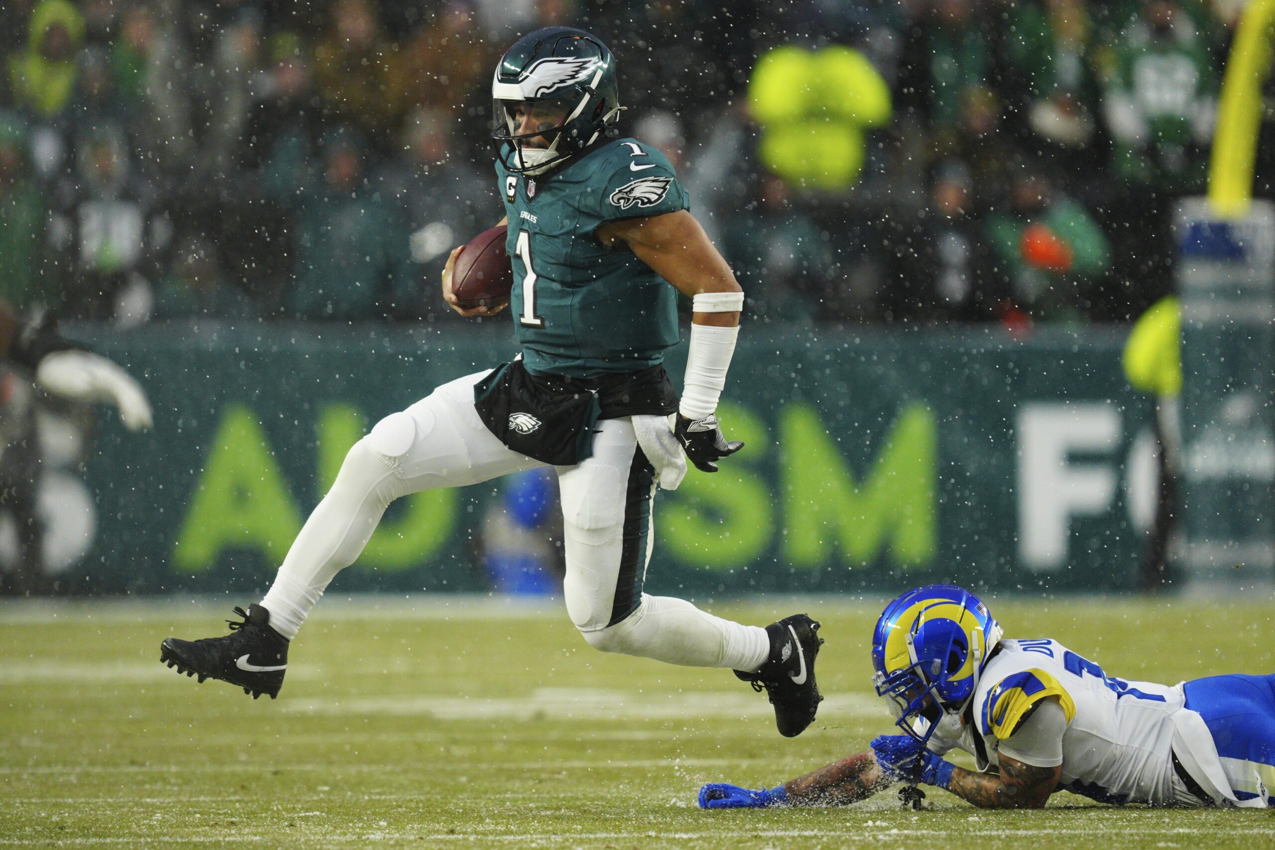 Philadelphia Eagles quarterback Jalen Hurts (1) runs with the ball...