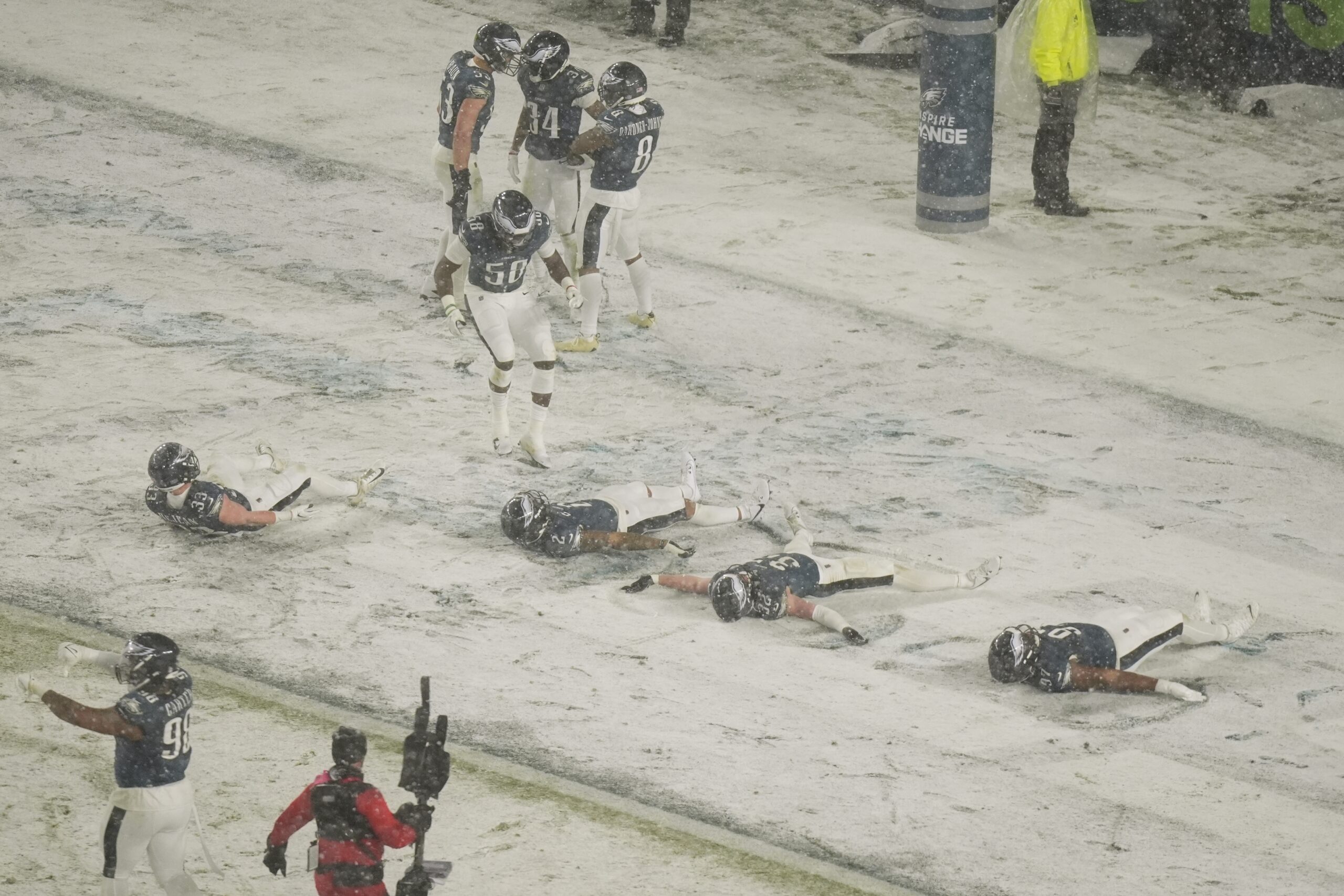 Philadelphia Eagles players do snow angels after Eagles cornerback Isaiah...