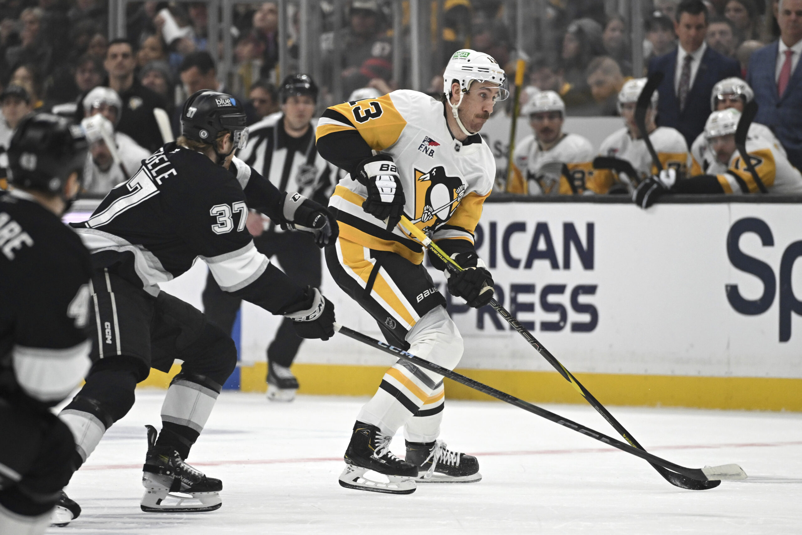 Pittsburgh Penguins right wing Kevin Hayes, right, controls the puck...