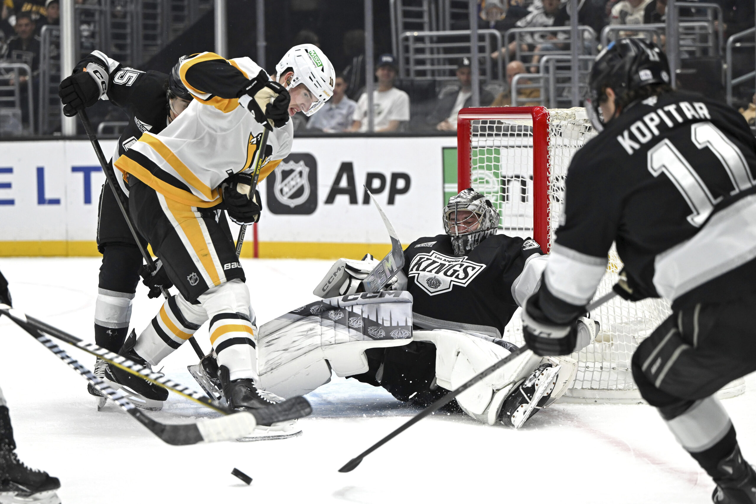 Pittsburgh Penguins left wing Drew O’Connor, front left, battles for...