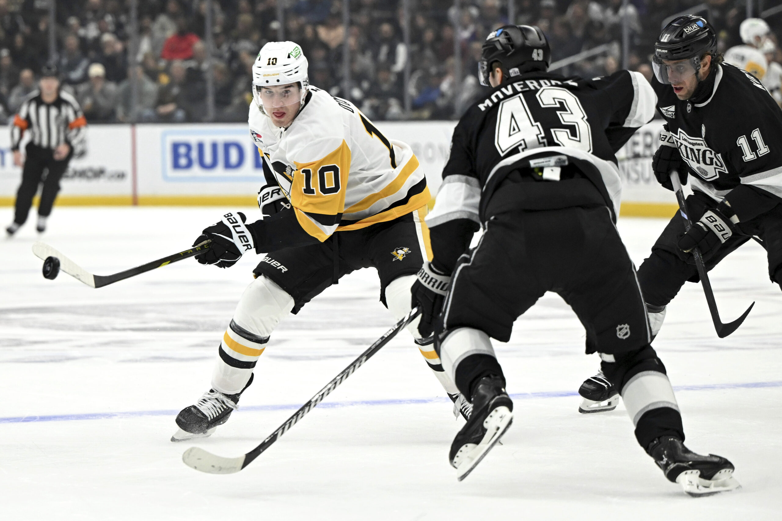 Pittsburgh Penguins left wing Drew O’Connor (10) passes the puck...