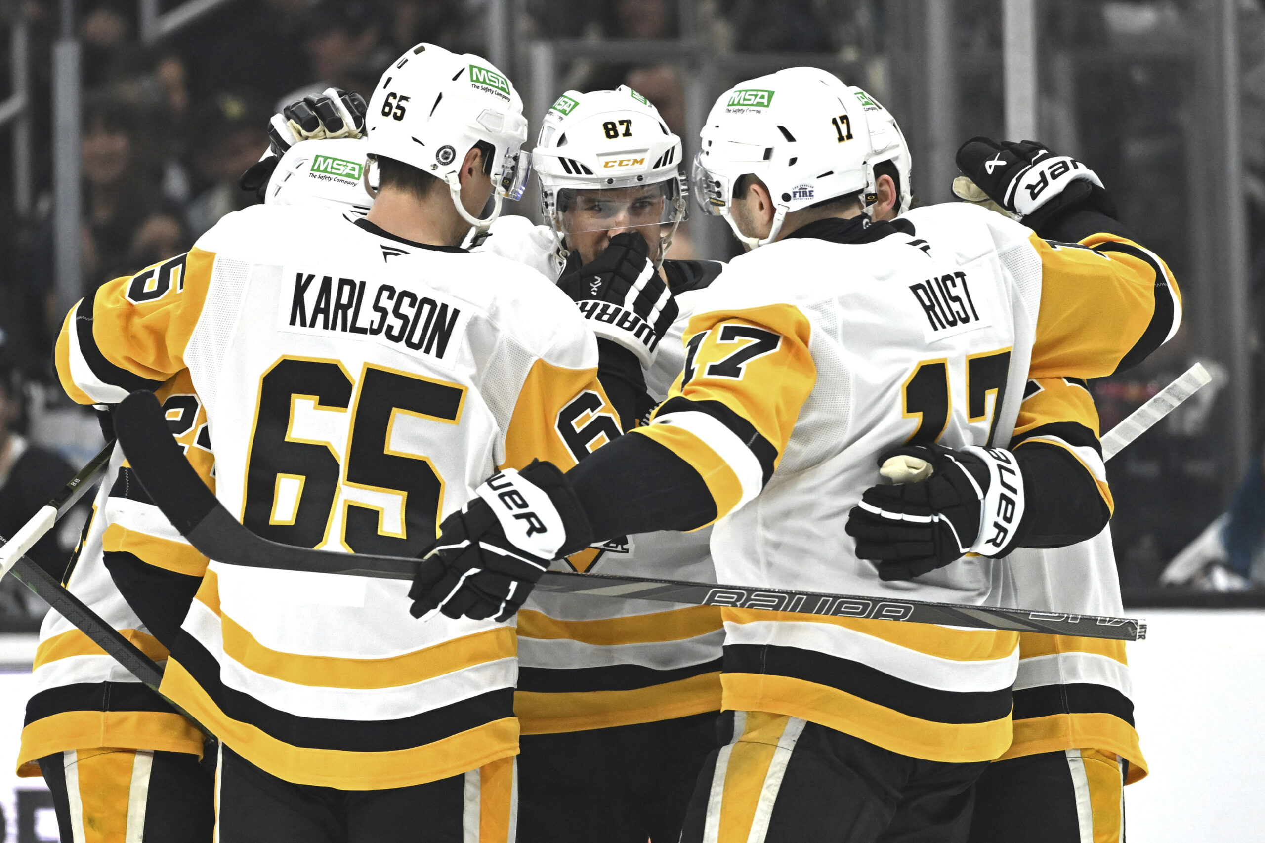 Pittsburgh Penguins center Sidney Crosby (87) is congratulated by teammates...