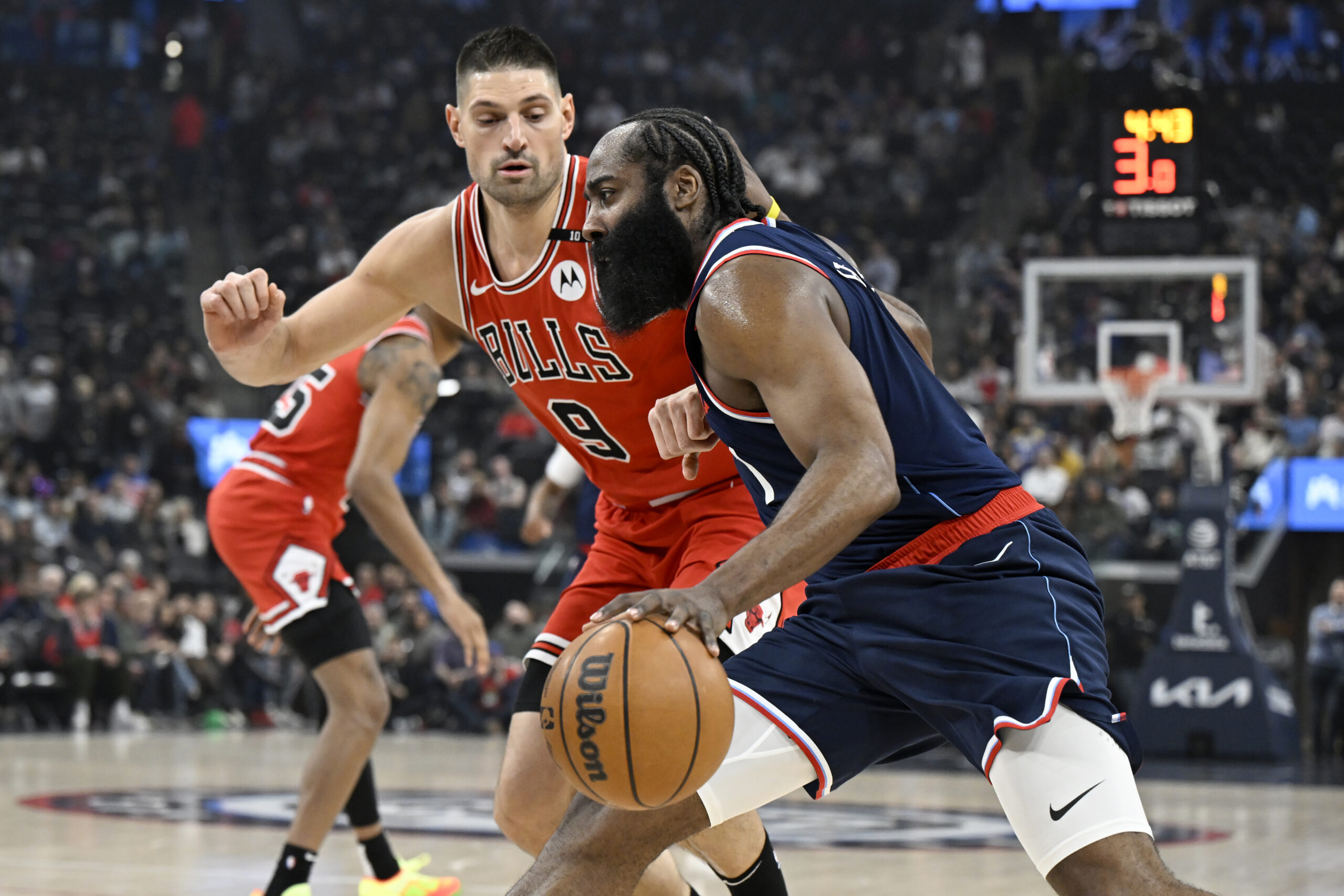 Clippers guard James Harden, right, drives as Chicago Bulls center...