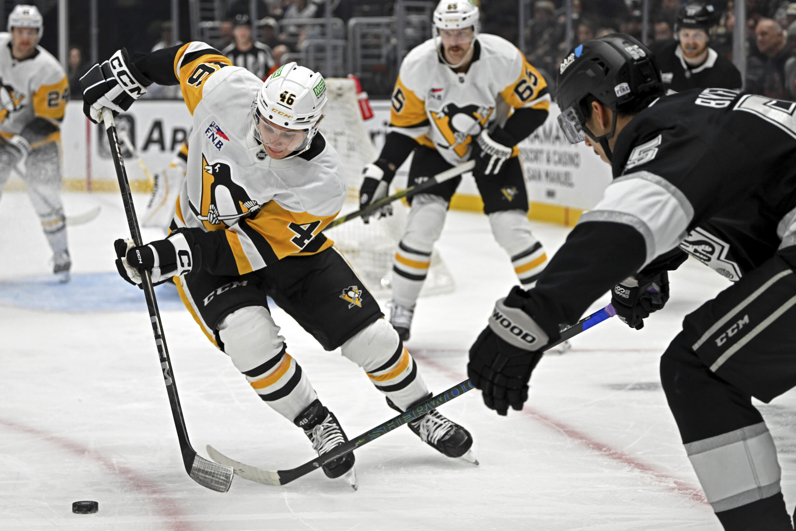 Pittsburgh Penguins center Blake Lizotte (46) controls the puck past...