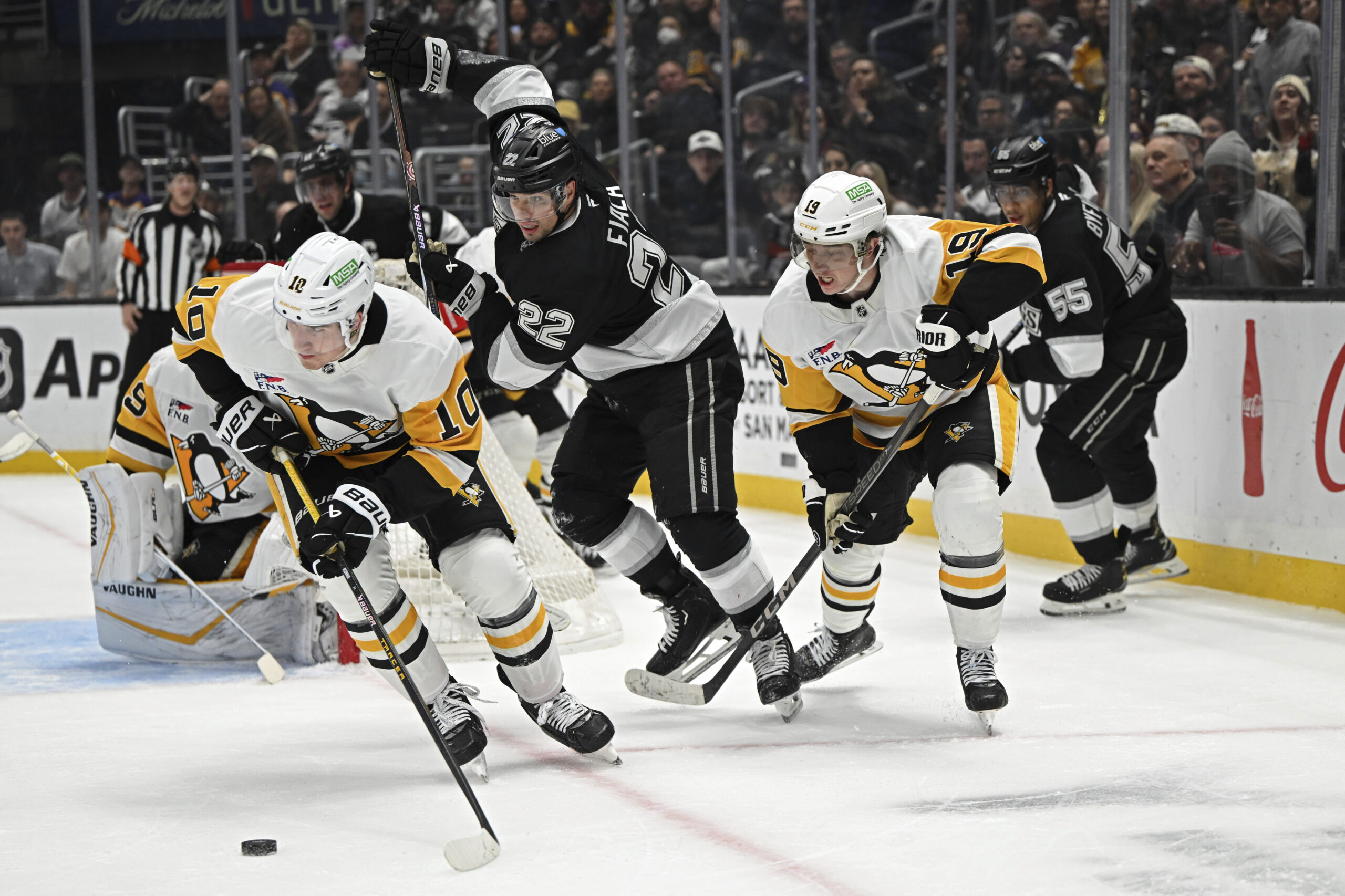 Pittsburgh Penguins left wing Drew O’Connor, left, gains control of...