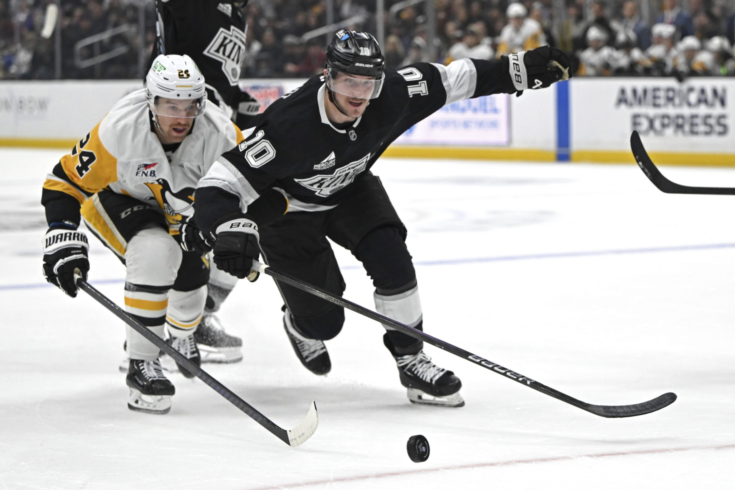 Pittsburgh Penguins defenseman Matt Grzelcyk, left, and Kings left wing...